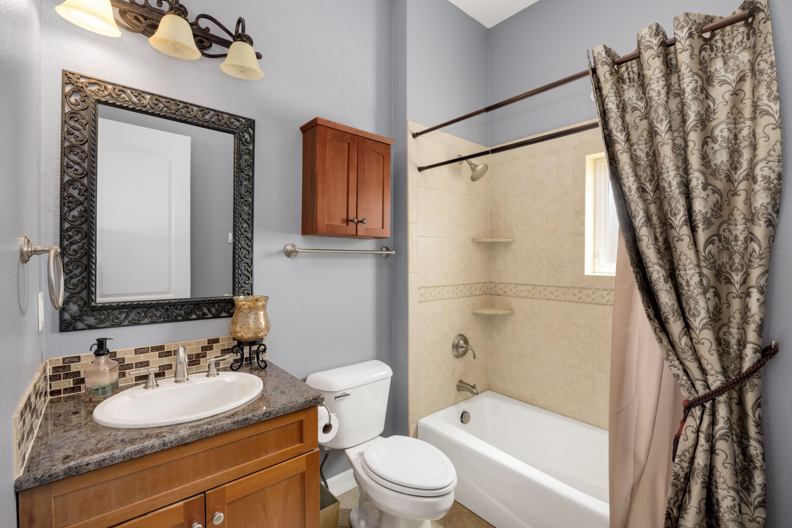 A stylish bathroom featuring modern amenities with classic design elements, perfect for home interiors.