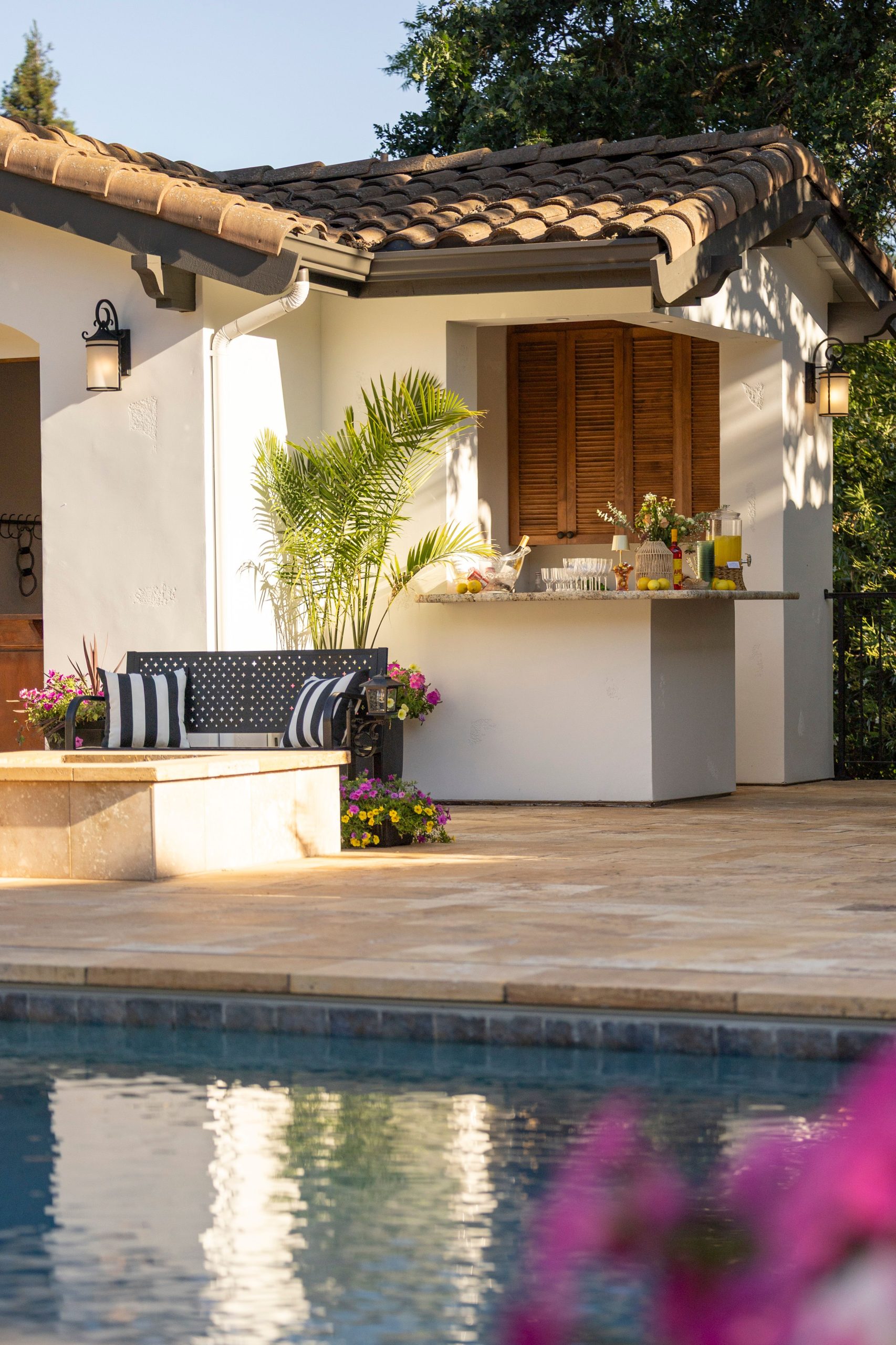 Beautiful outdoor patio with seating and poolside bar, perfect for relaxing in the summer.