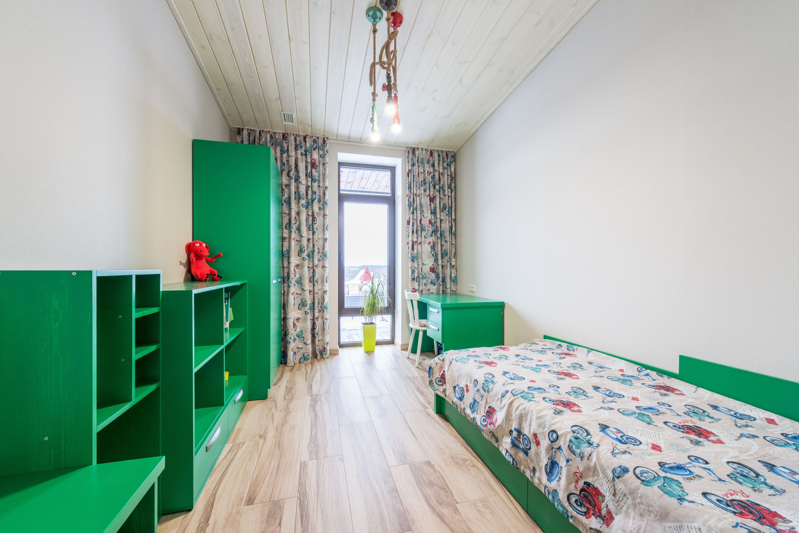 Bright child room with green furniture and playful decor, perfect for a creative space.