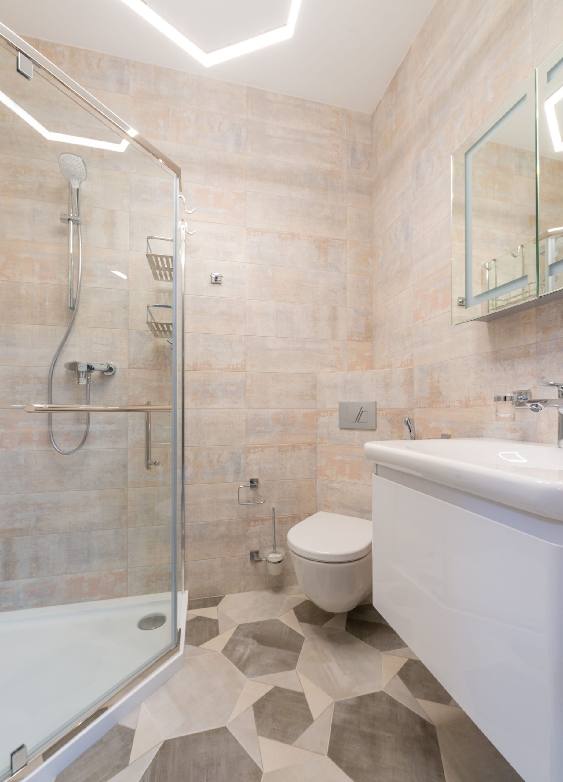 Bright, clean bathroom featuring ceramic tiles, a glass shower, and modern fixtures.