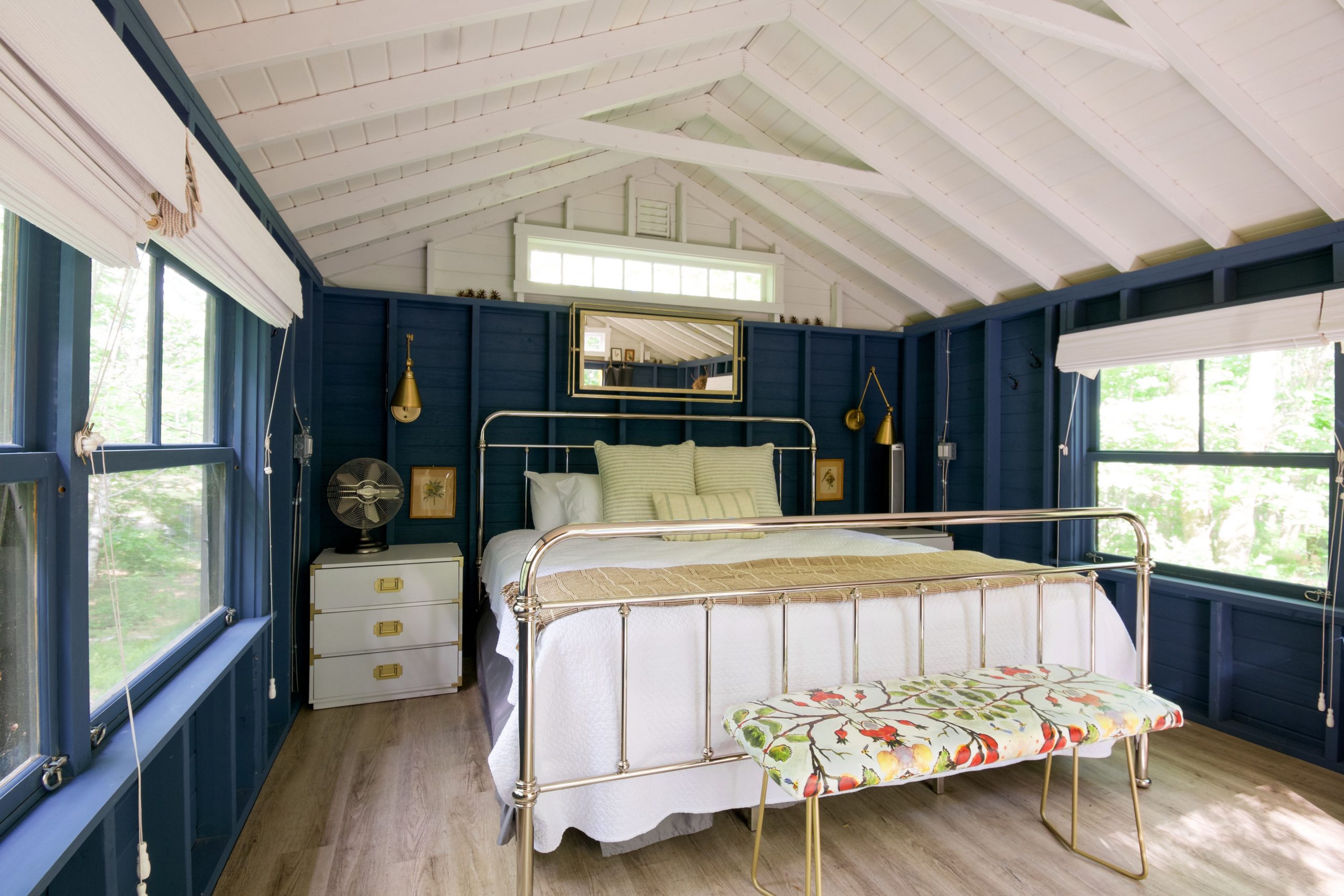 Bright coastal-themed bedroom with stylish decor and natural light.