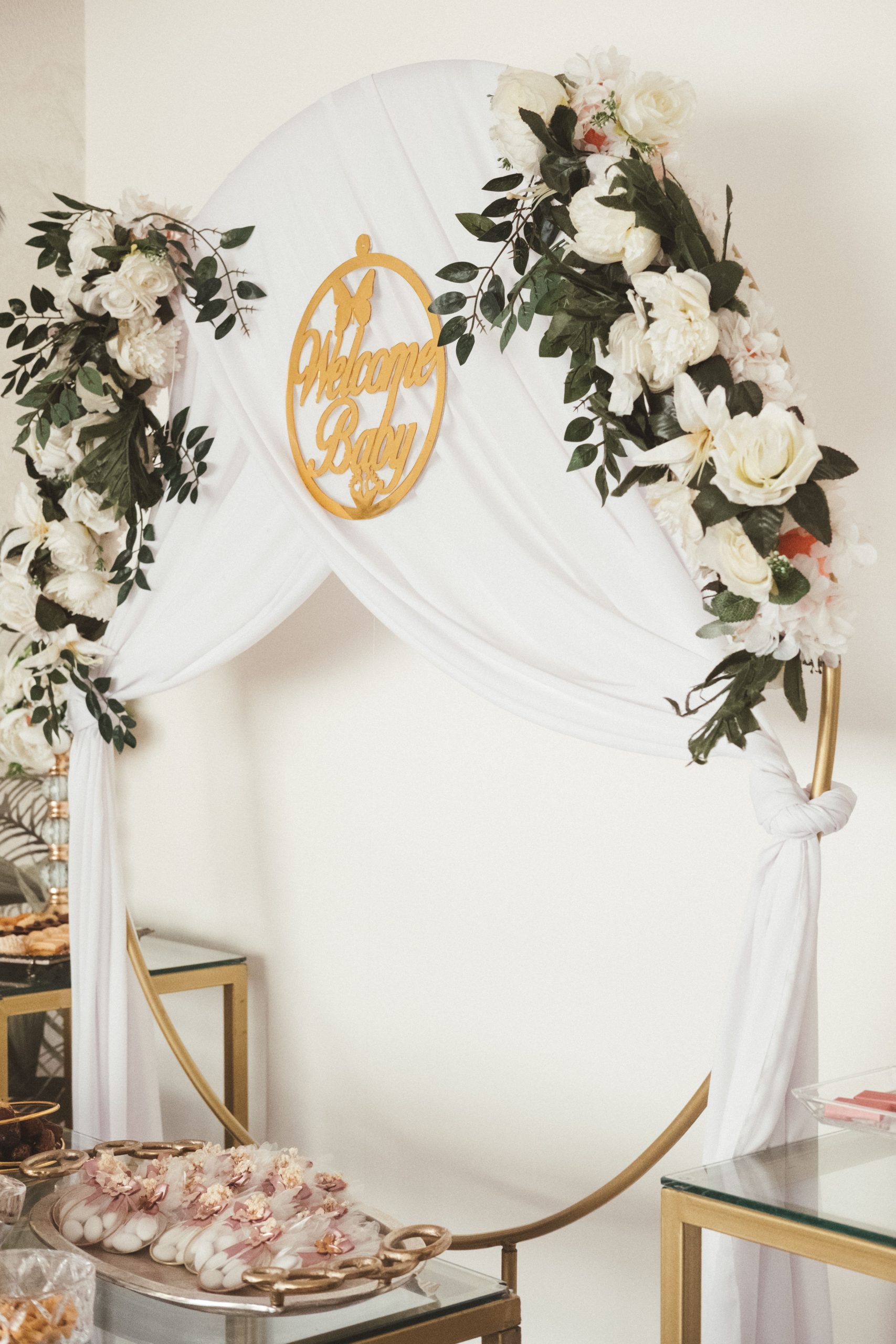 Elegant baby shower setup with floral arch and welcome sign in Rabat.