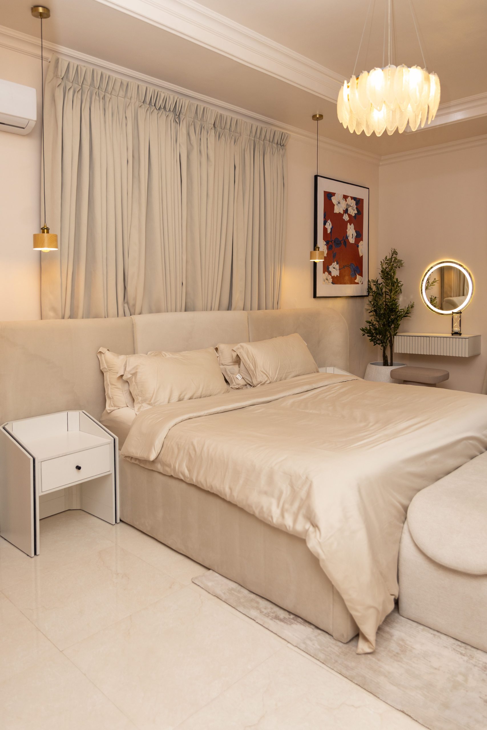 Elegant bedroom with beige tones, soft lighting, and modern decor.