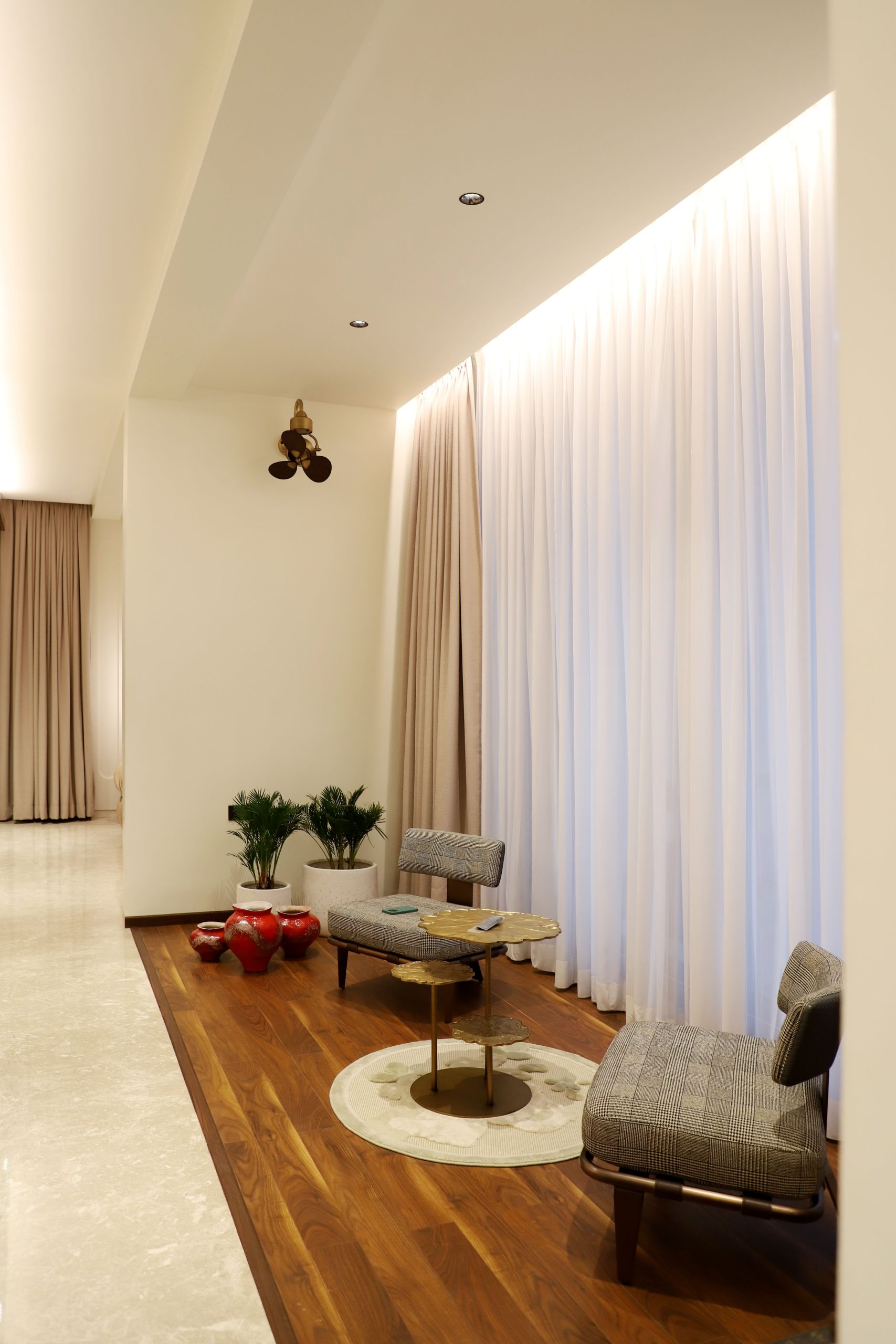 Elegant indoor space featuring stylish chairs, curtains and decor in a modern setting.
