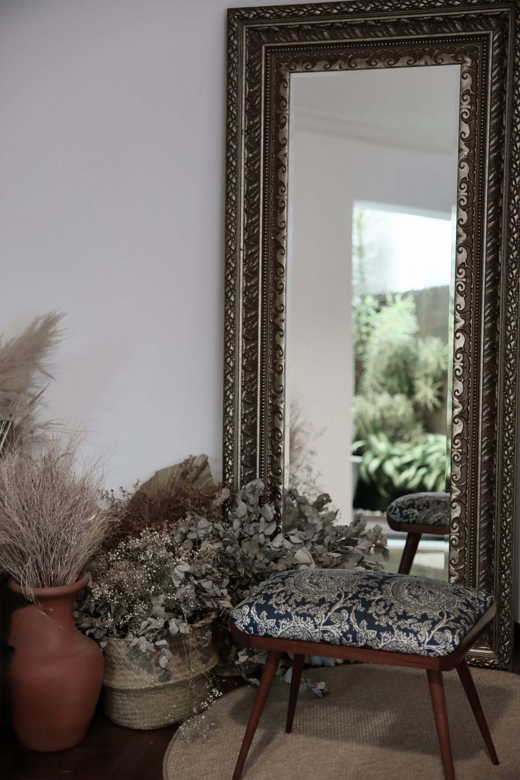 Elegant living space featuring a large ornate mirror and decorative floral elements.