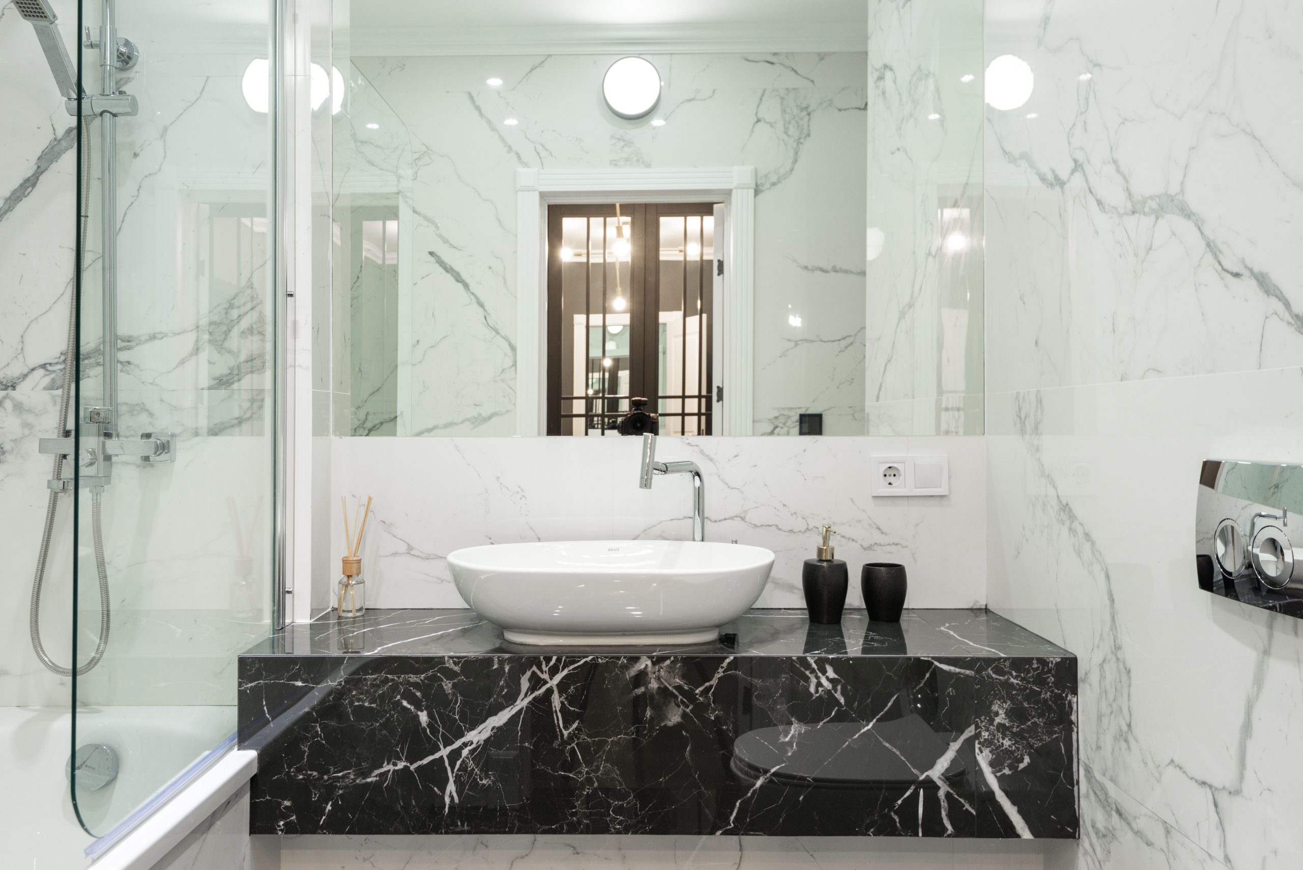 Elegant marble bathroom featuring modern sink and fixtures.