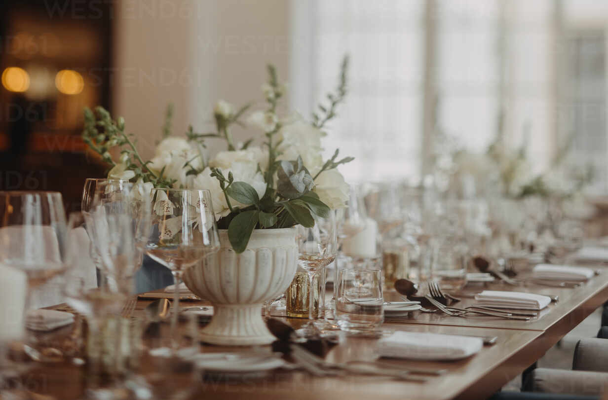 Elegant, romantic table setting for indoor wedding reception, celebration. Luxury wedding table decoration, special event table set up with fresh flowers arragements. stock photo