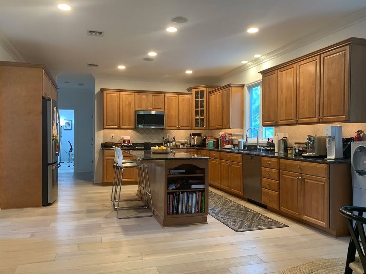 He Spray Painted the Orange Oak Cabinets an Almost-Black Blue and the Kitchen Took on a Custom-Built Look