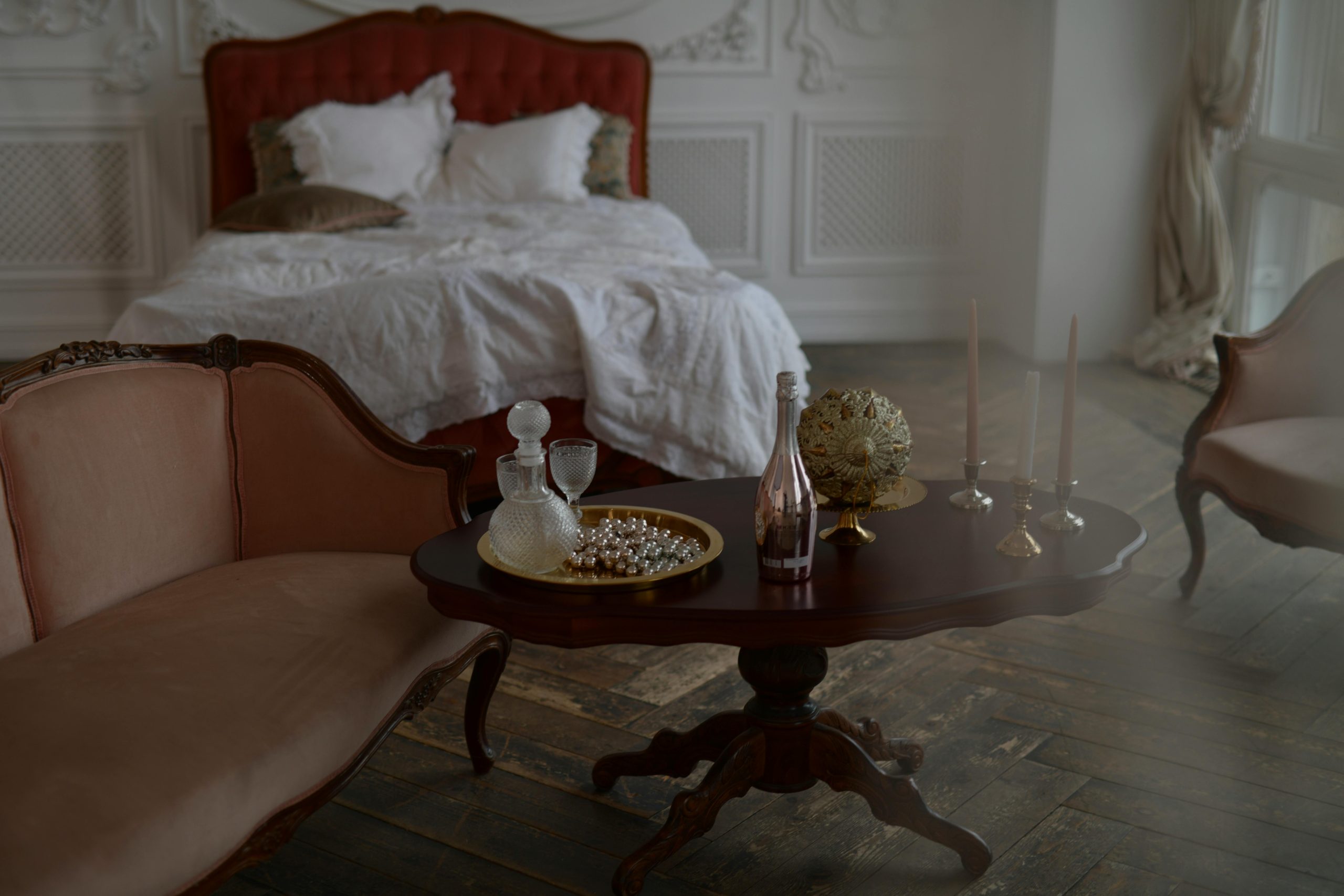 Luxurious vintage bedroom with ornate furniture and soft lighting creates a serene ambiance.
