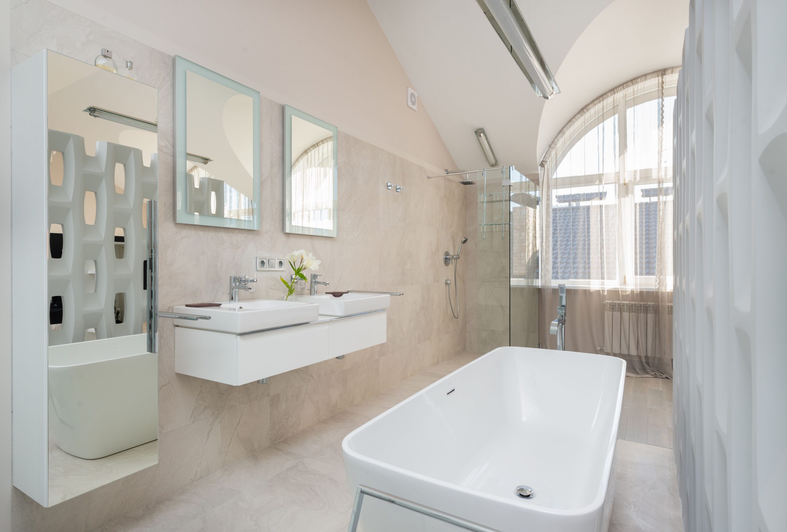 Modern bathroom with big window and glass shower cabin and white bath and double sink with mirrors