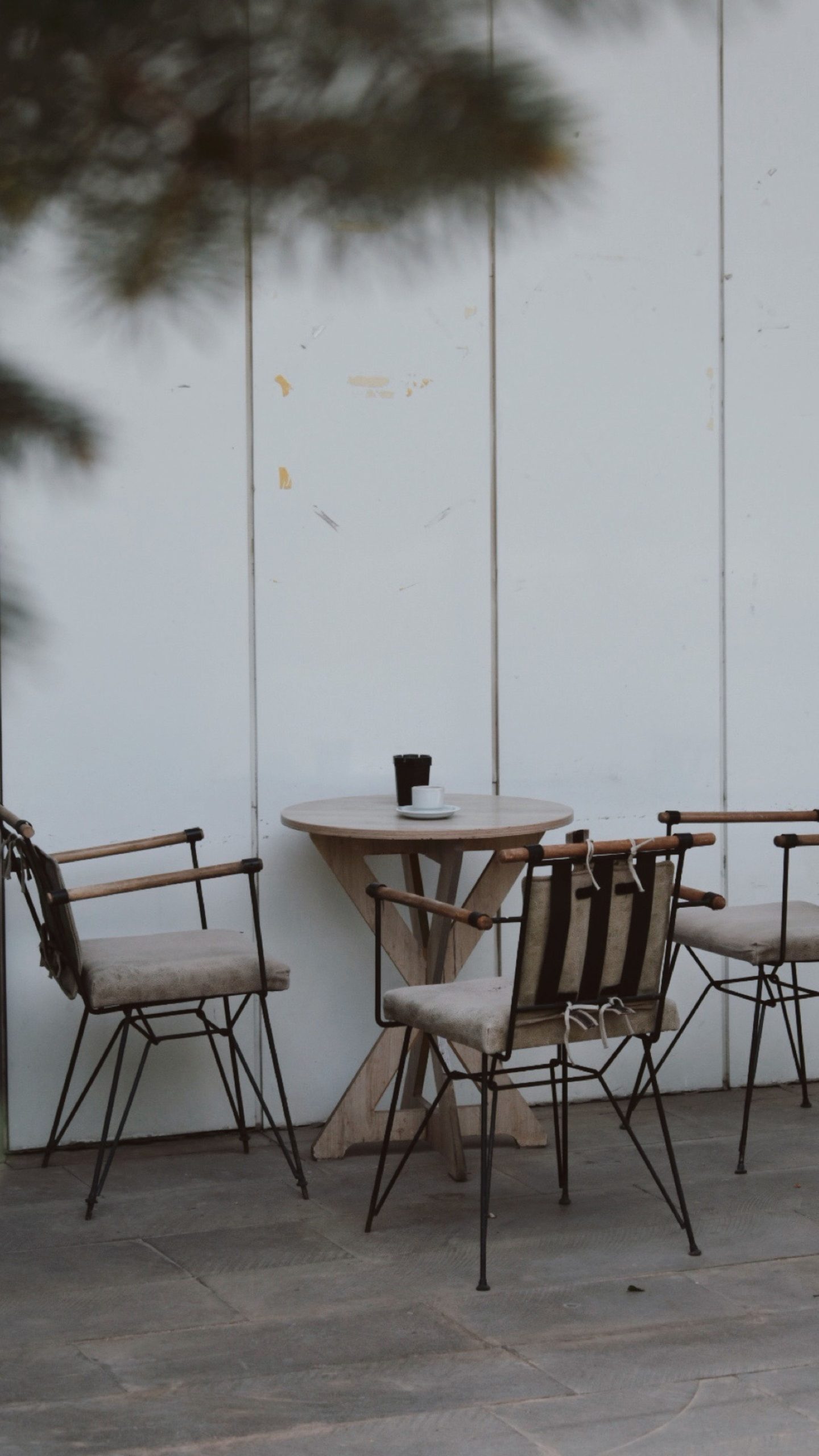 Outdoor patio setting with wooden table and chairs, a perfect spot for relaxation.