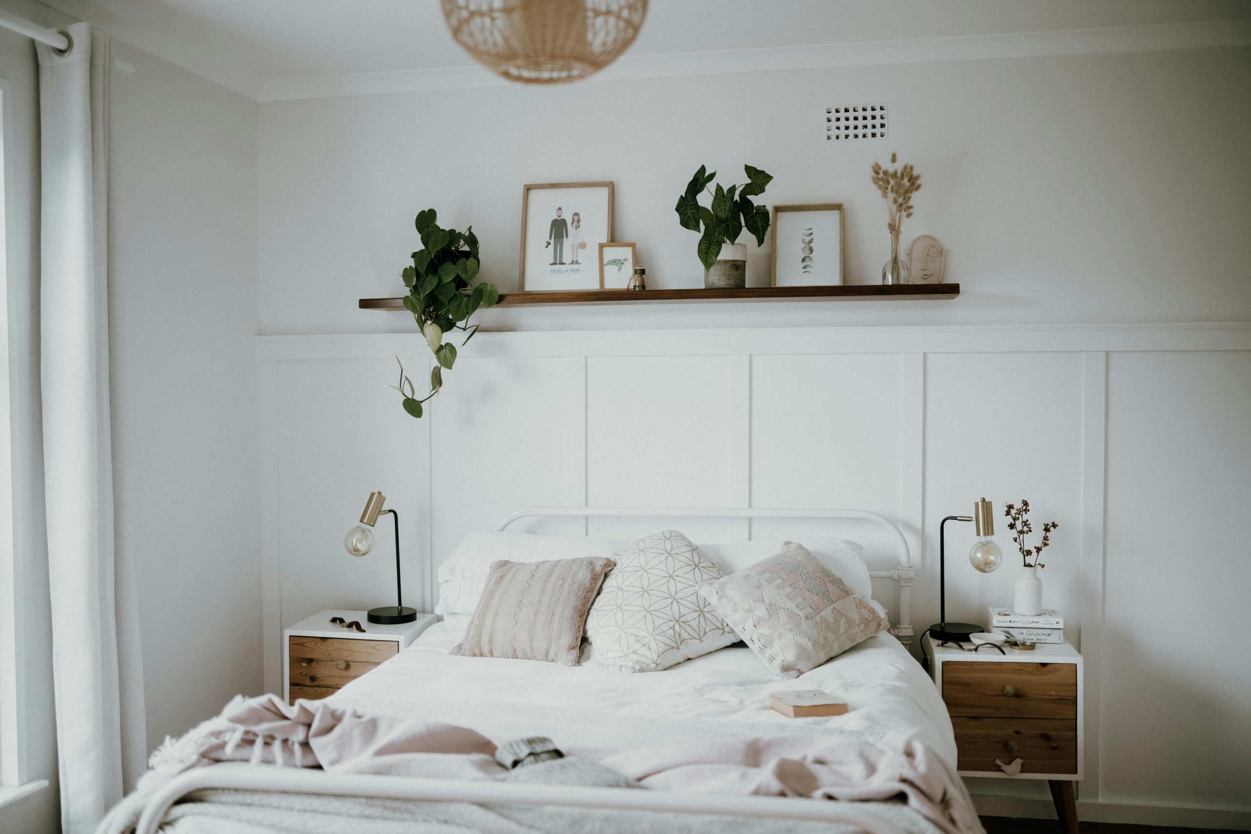 Scandinavian style bedroom featuring minimalist decor, natural light, and indoor plants.