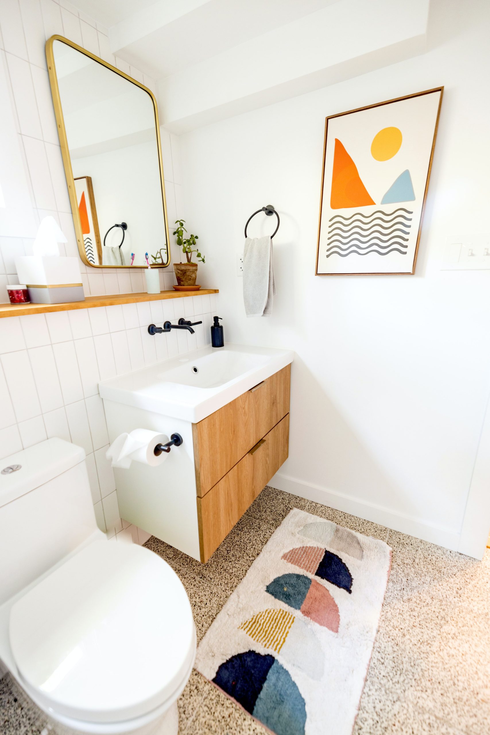 Sleek bathroom interior featuring abstract wall art and minimalist decor in Catskill, NY.