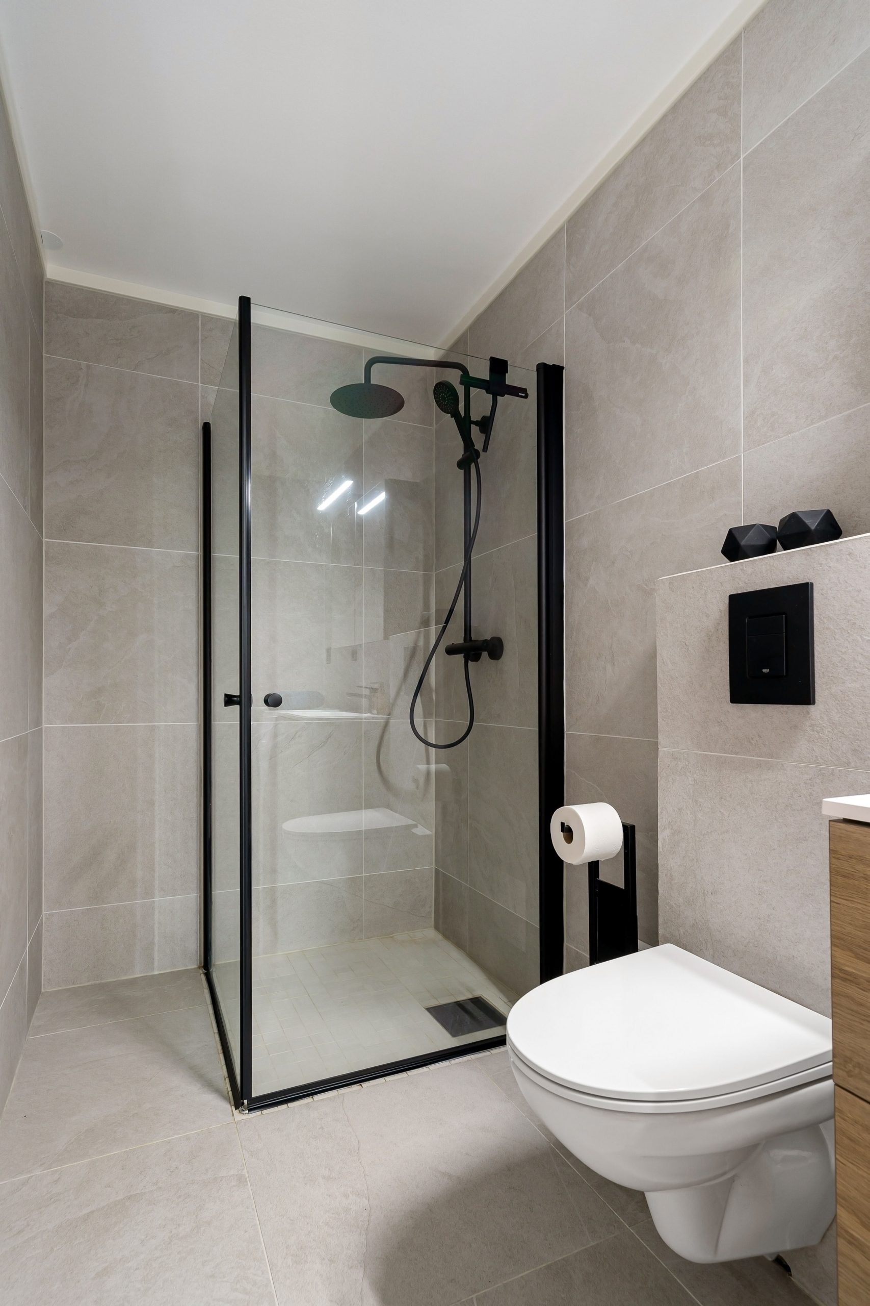 Sleek modern bathroom featuring a frameless glass shower and minimalist design.