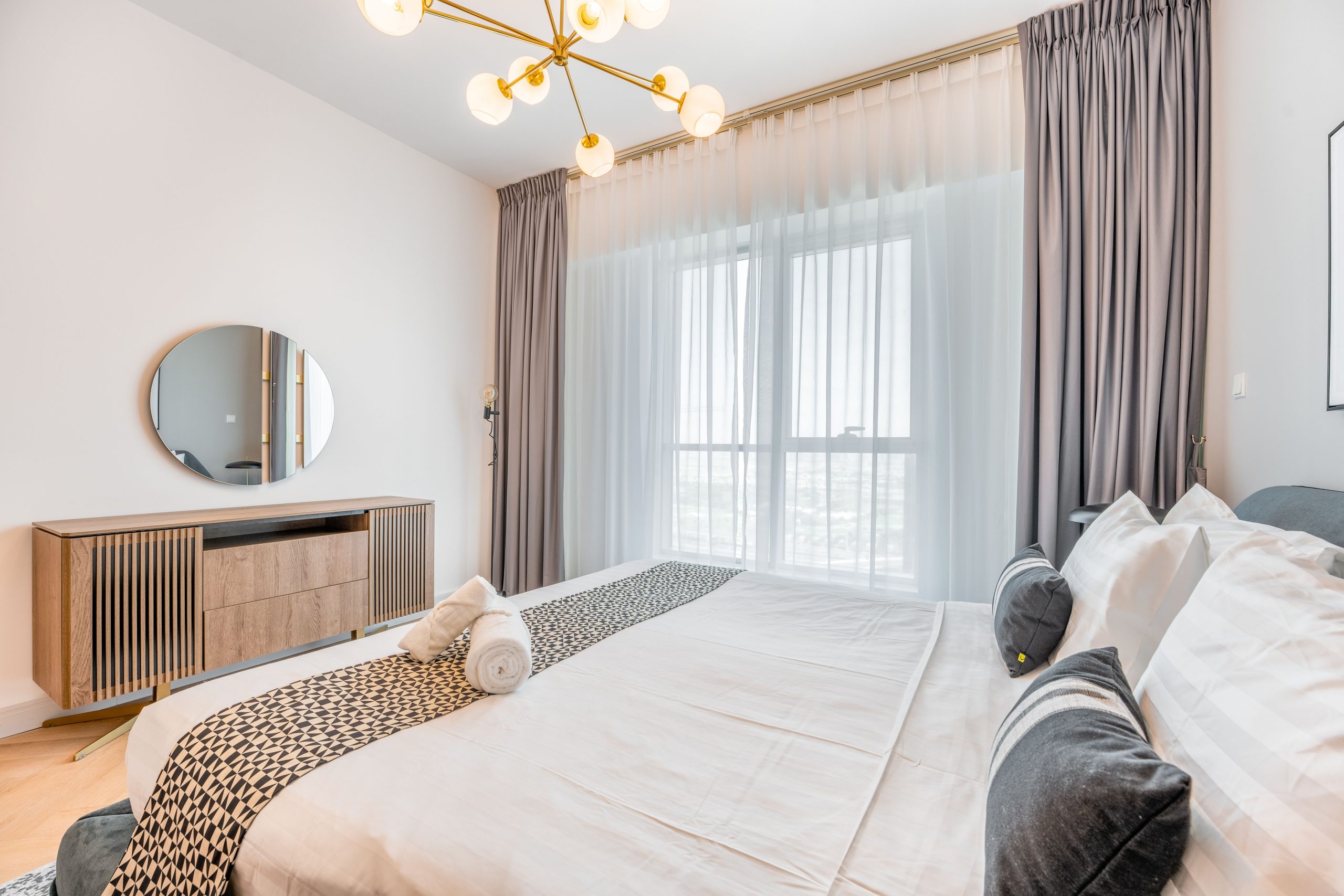 Spacious modern bedroom with elegant design and natural light.