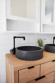 Stone Vessel Sink On Oak Vanity In Rustic Farmhouse Bathroom' by Stocksy Contributor 'Trinette Reed' - Stocksy