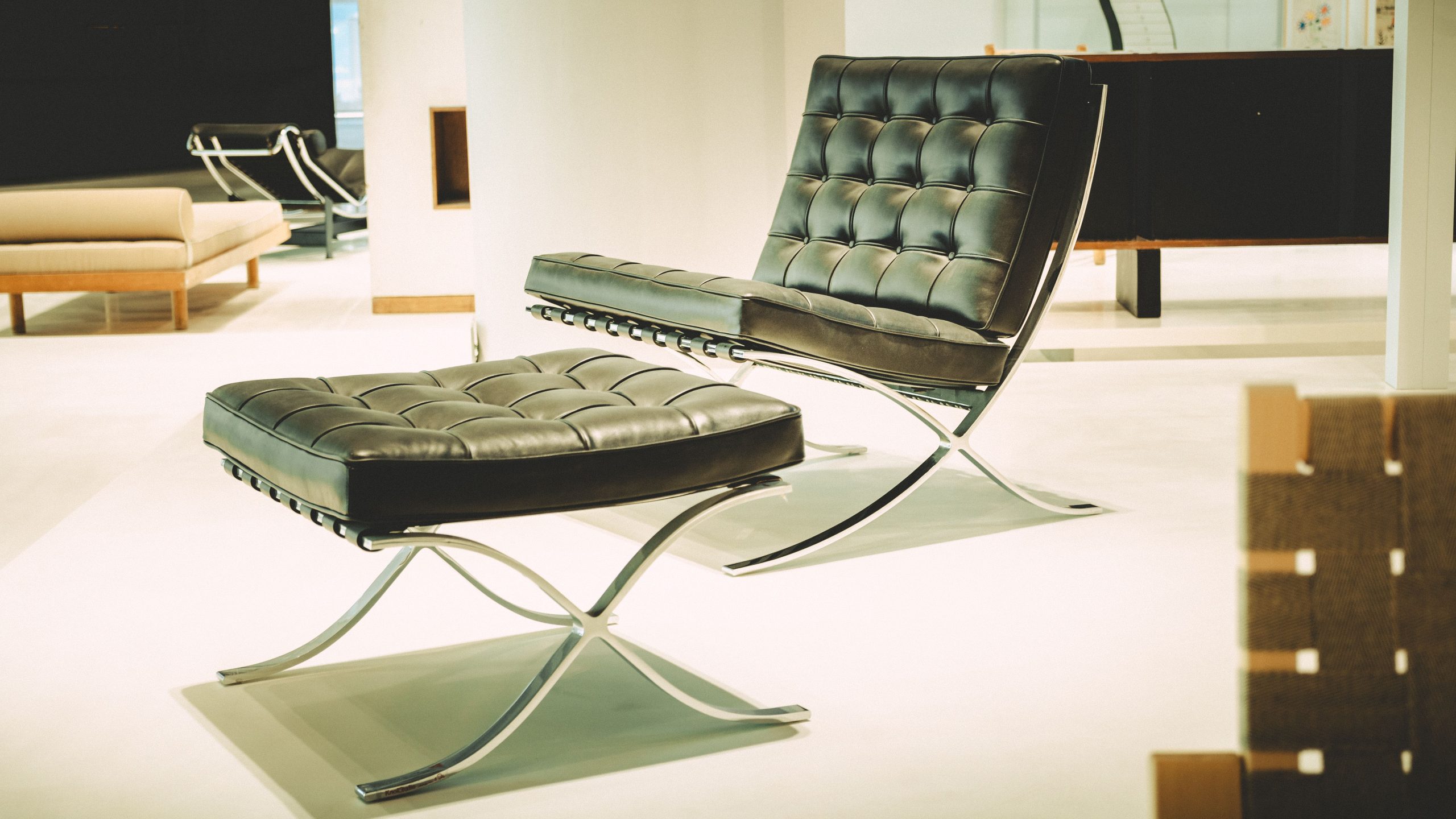 Stylish black leather lounge chair with ottoman in a modern setting, ideal for interior design inspiration.