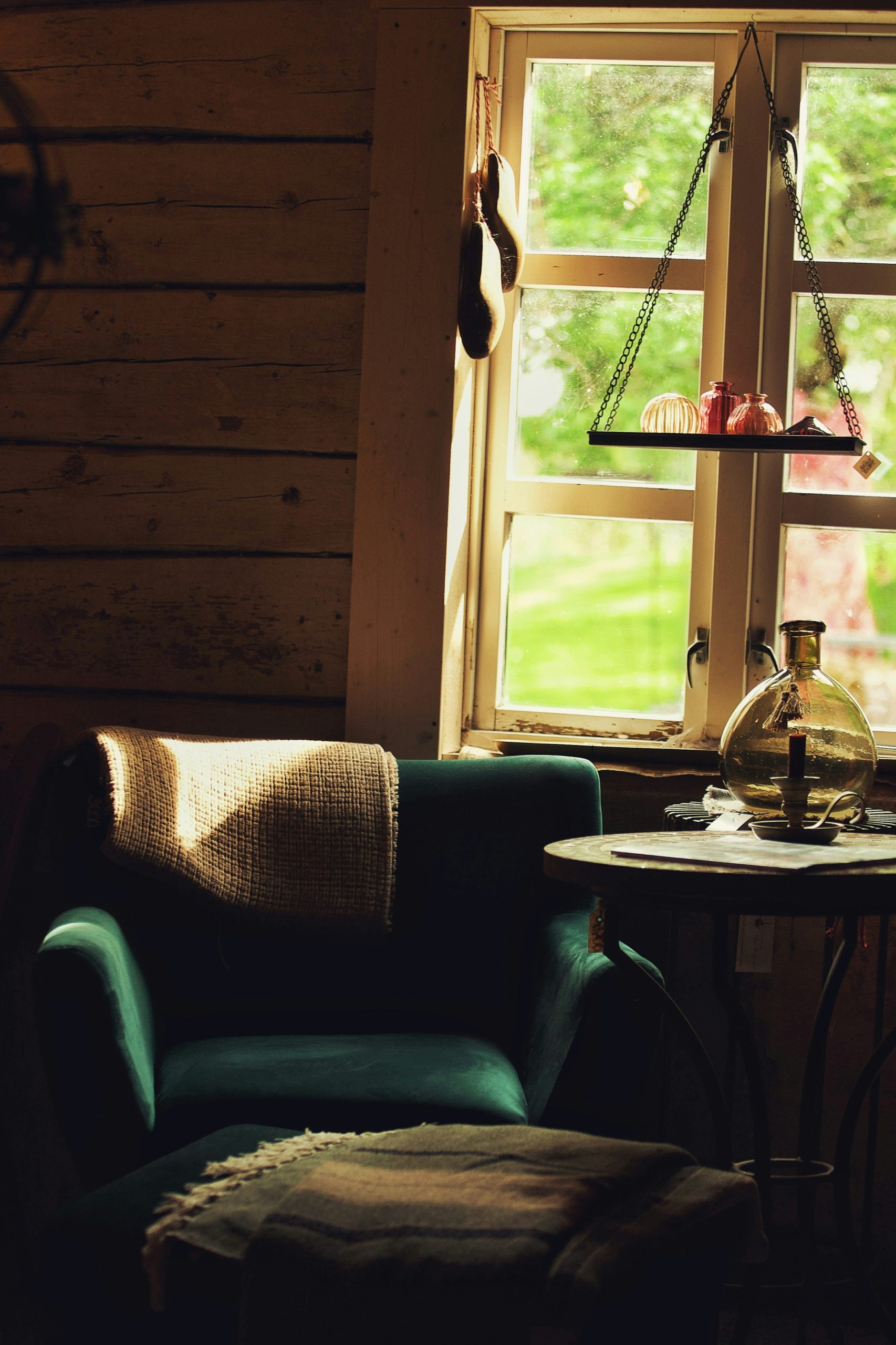 Vintage indoor interior and decorations in a dark living room with light shining through the window.