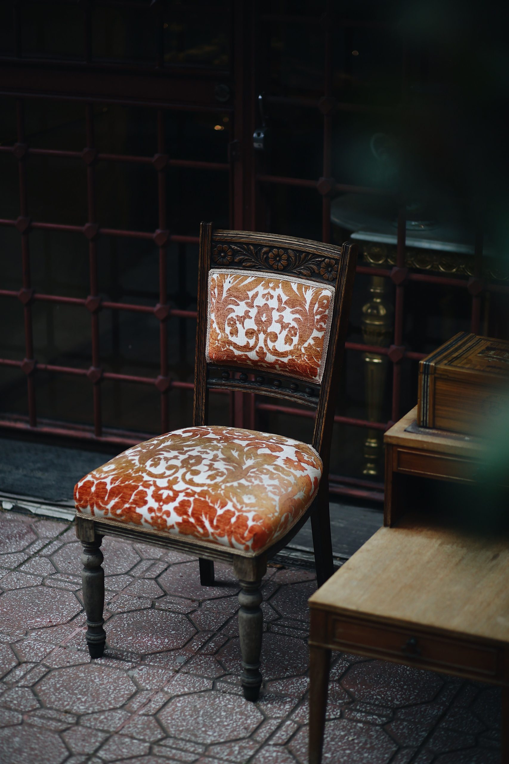 Vintage upholstered chair with floral pattern in an Istanbul patio setting.