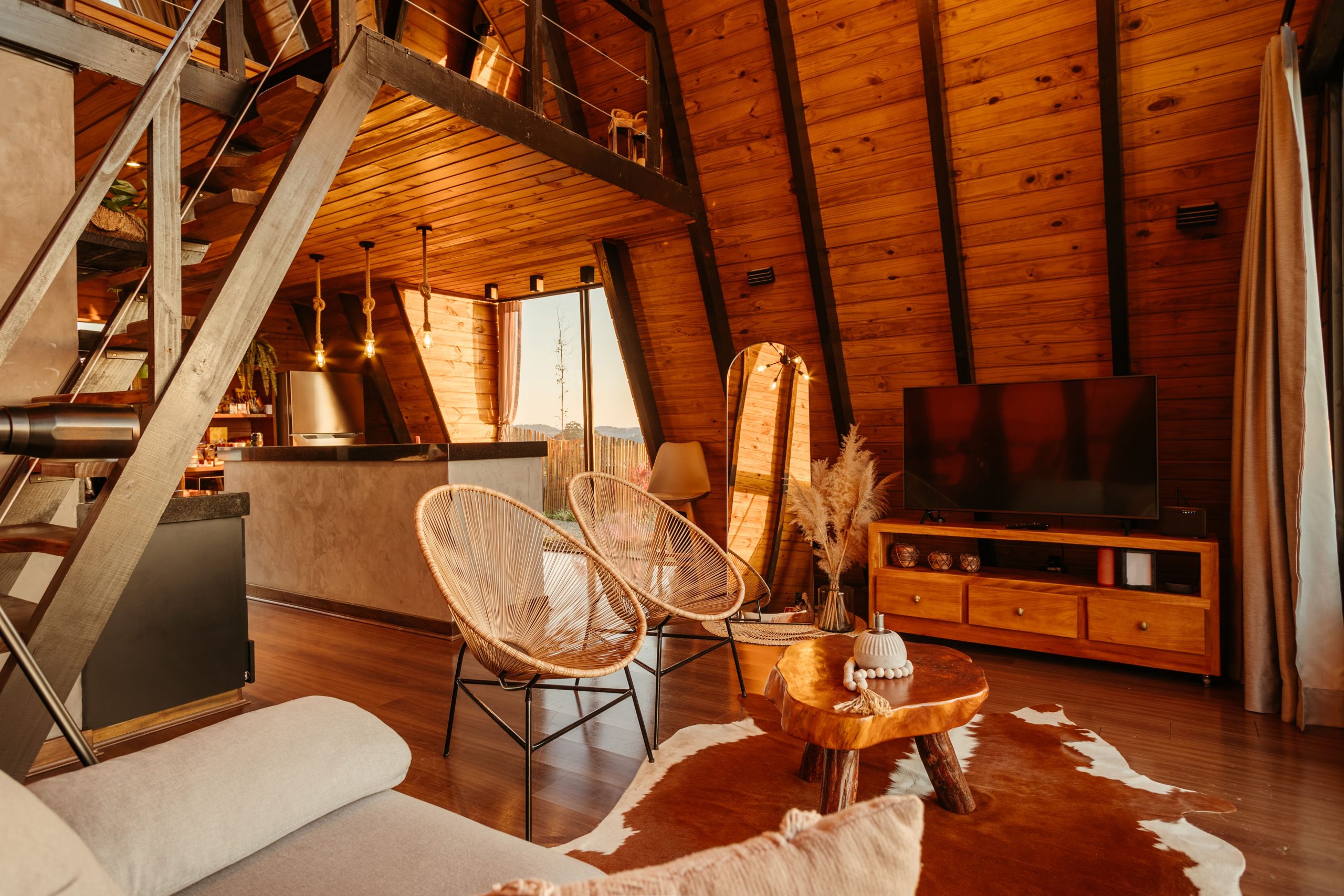 Warm and inviting A-frame cabin interior featuring rustic design and wooden elements.