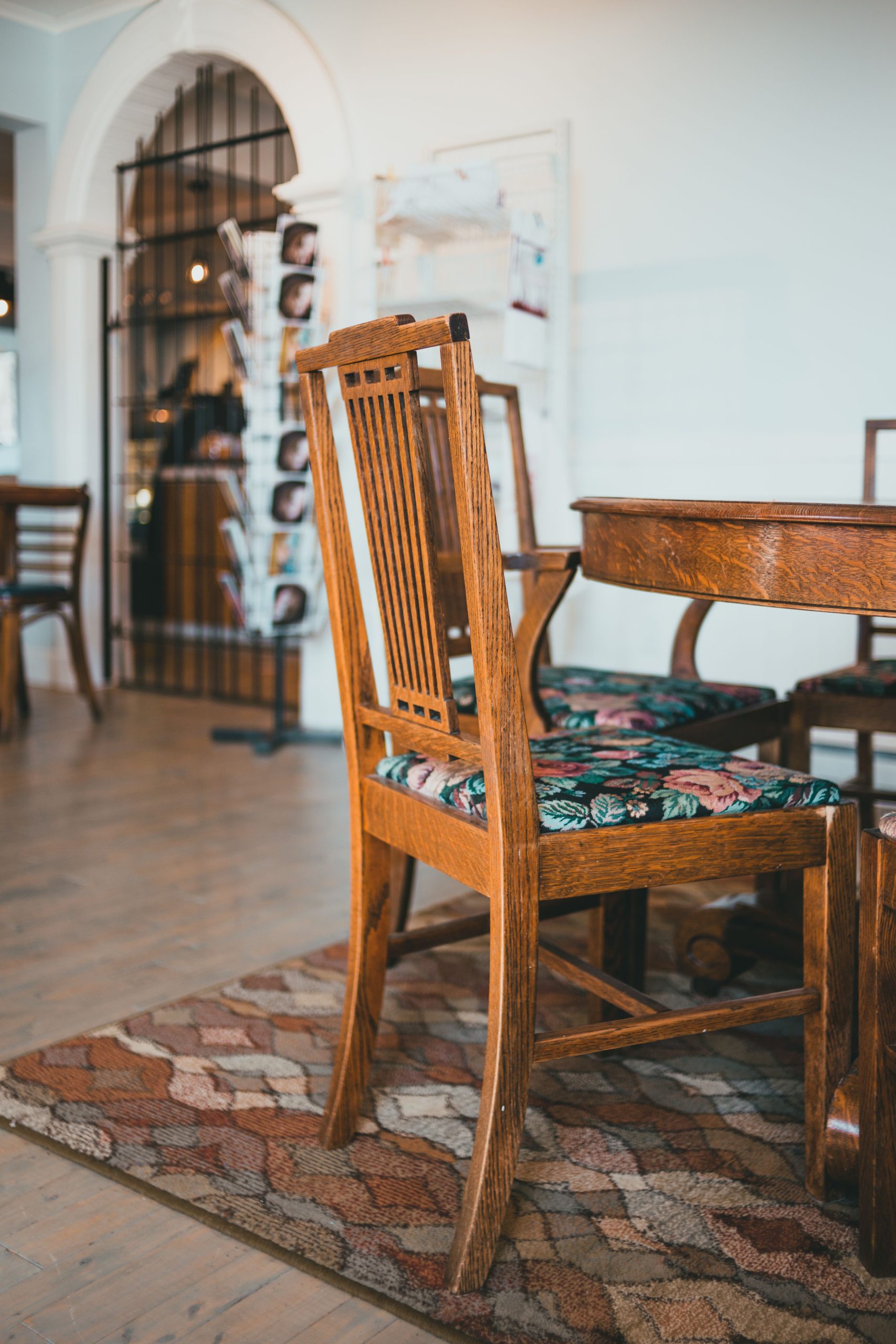 Warm interior scene featuring a vintage wooden dining set with floral upholstery.