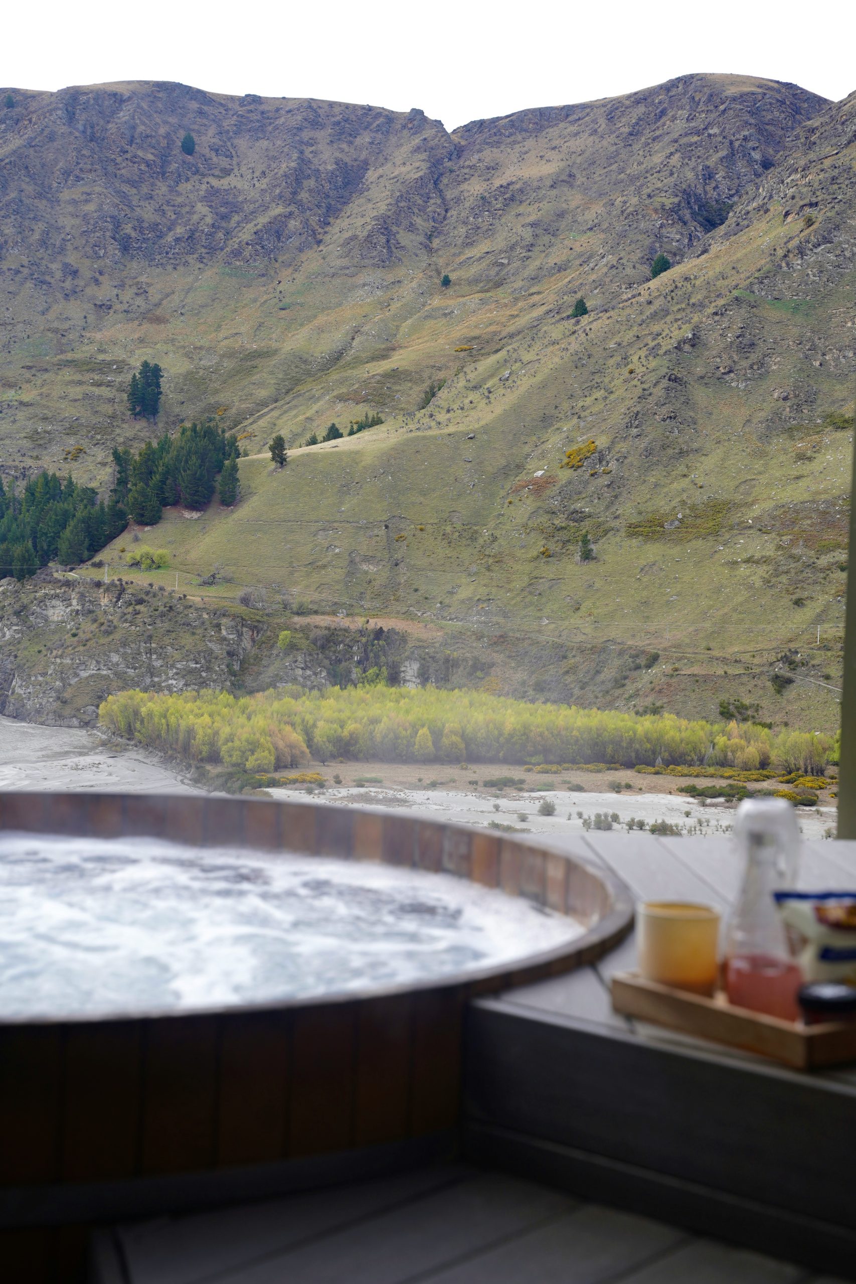 A hot tub with a mountain view in the background