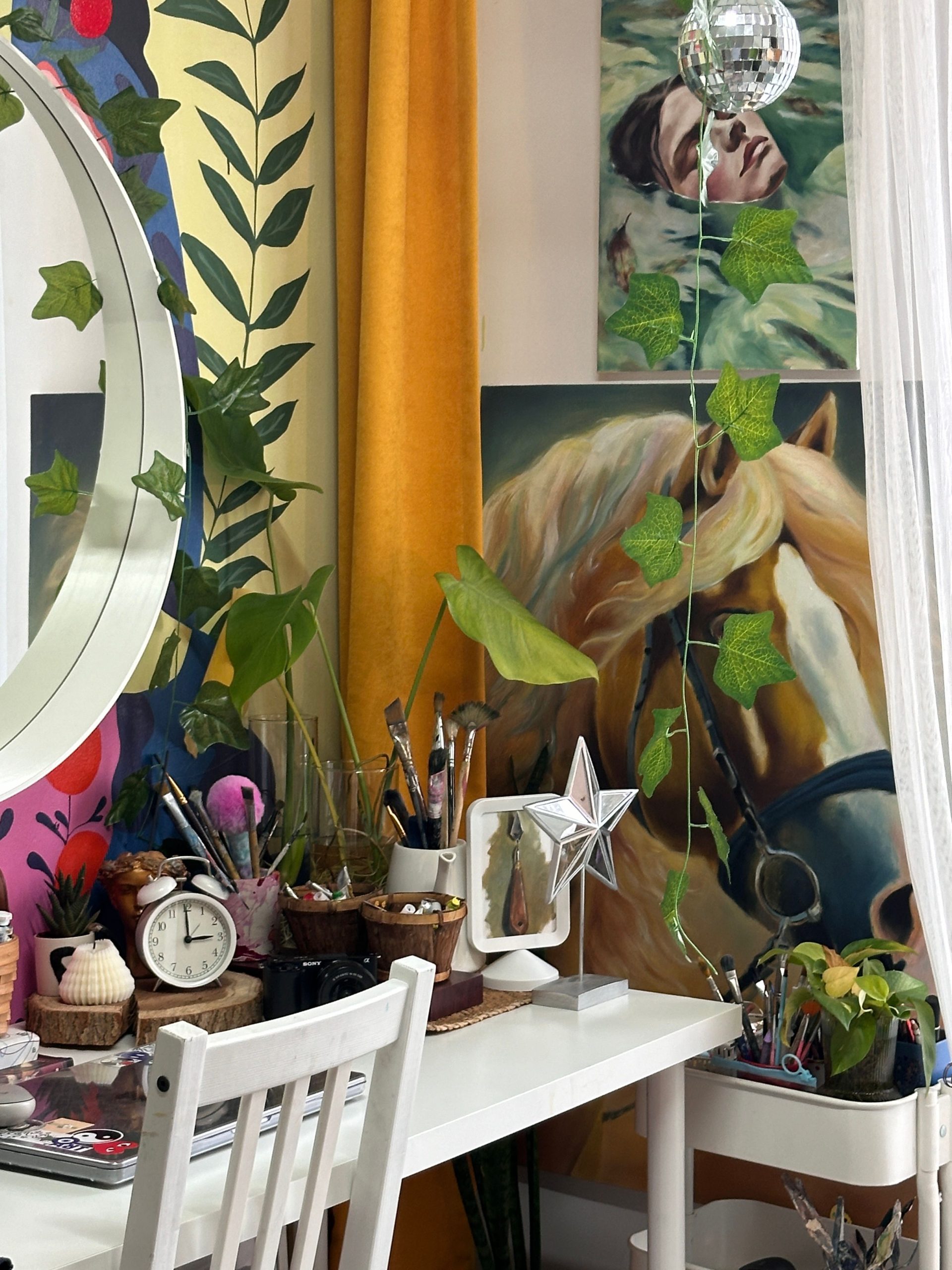 Art studio with diverse tools and plants, featuring vibrant paintings and unique decor.