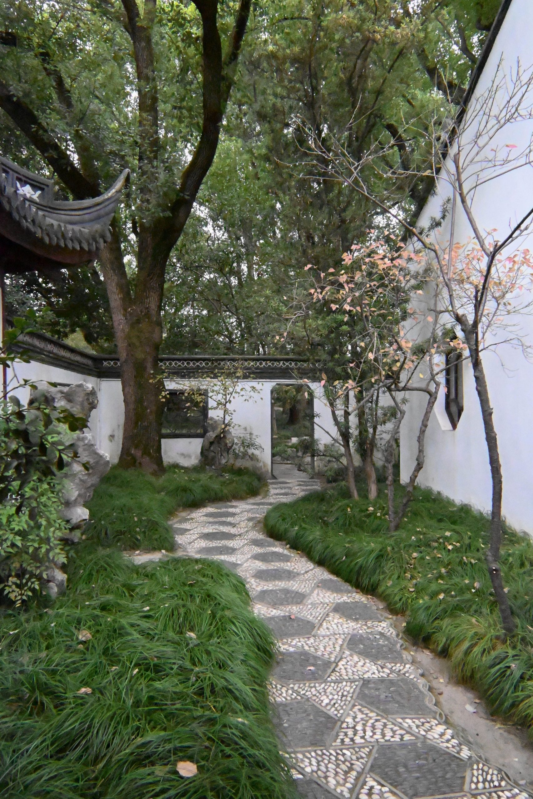 Beautiful quiet pathway through a lush Chinese garden in autumn.