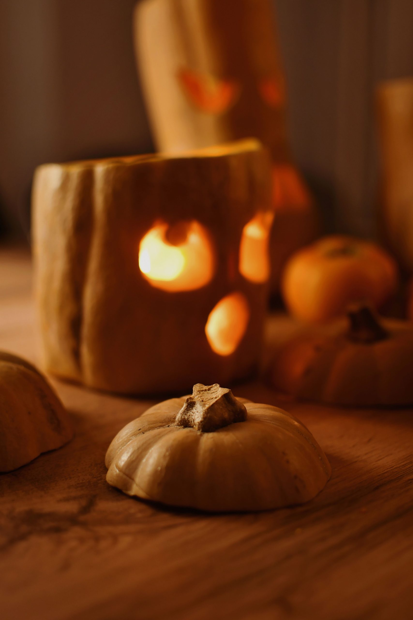 Carved pumpkins emit a soft glow, perfect for cozy Halloween ambiance.
