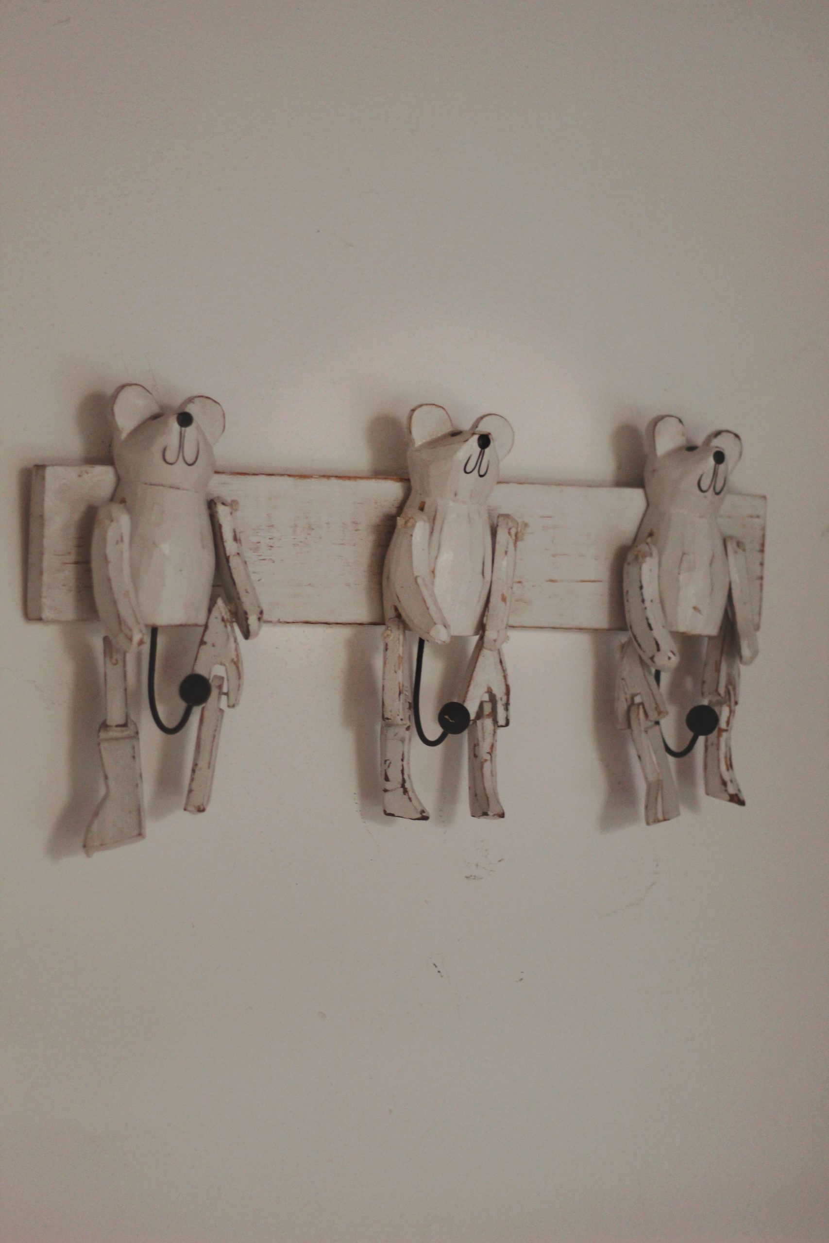 Charming rustic bear coat rack mounted on a wall, perfect for adding character to home decor.