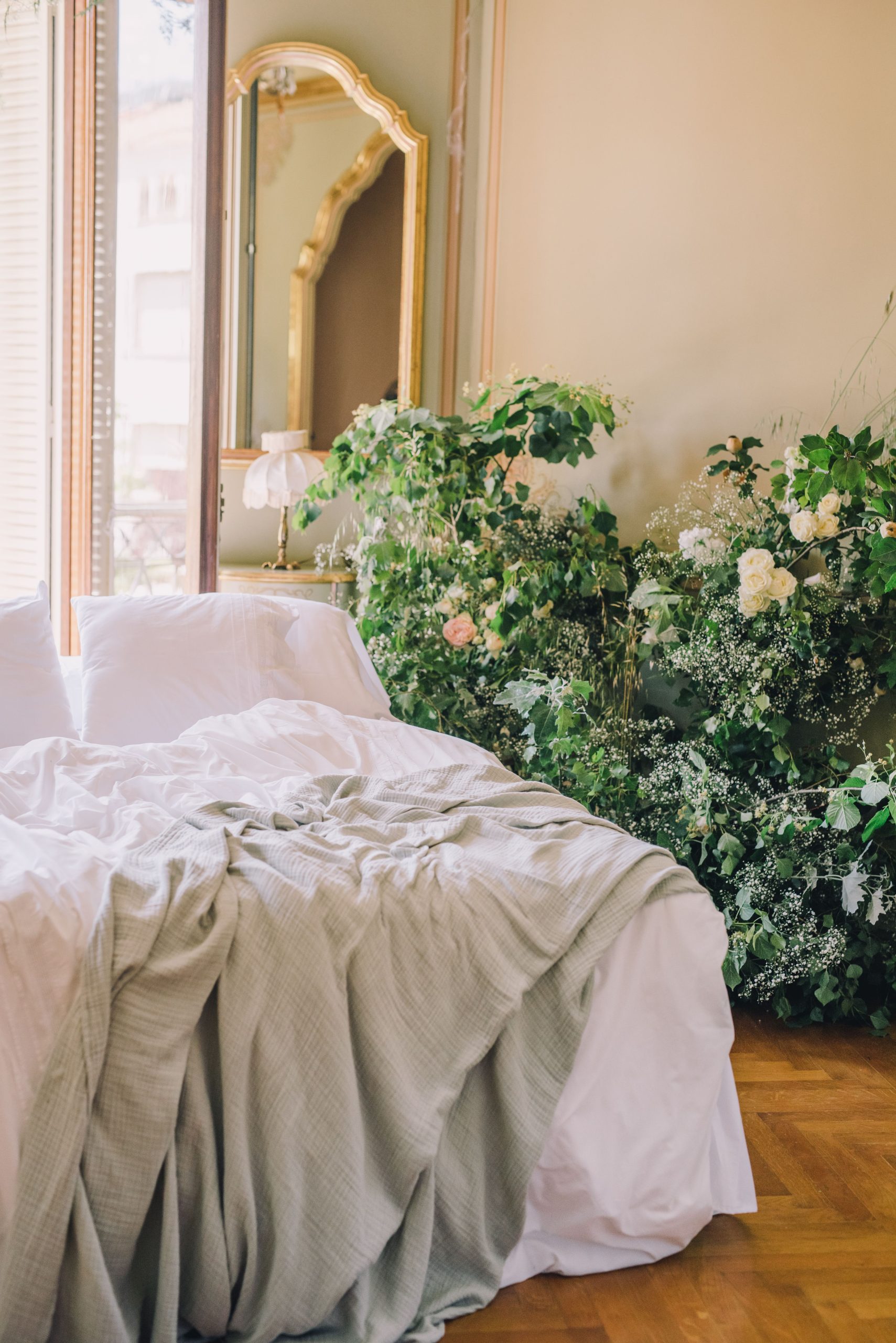 Elegant bedroom with lush greenery and vintage decor, perfect for luxury interiors.