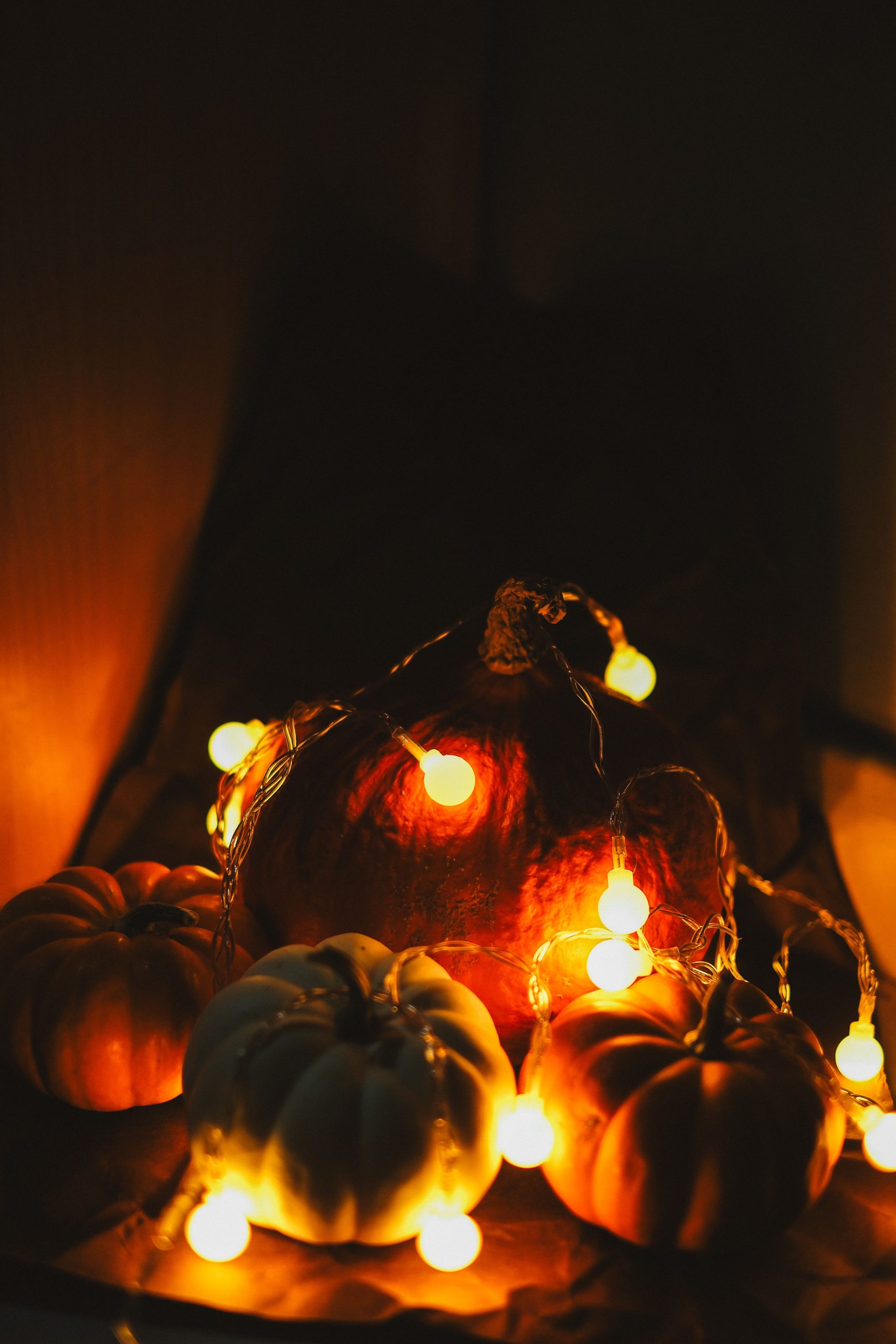 Festive Halloween scene featuring pumpkins and warm glowing lights creating a spooky atmosphere.