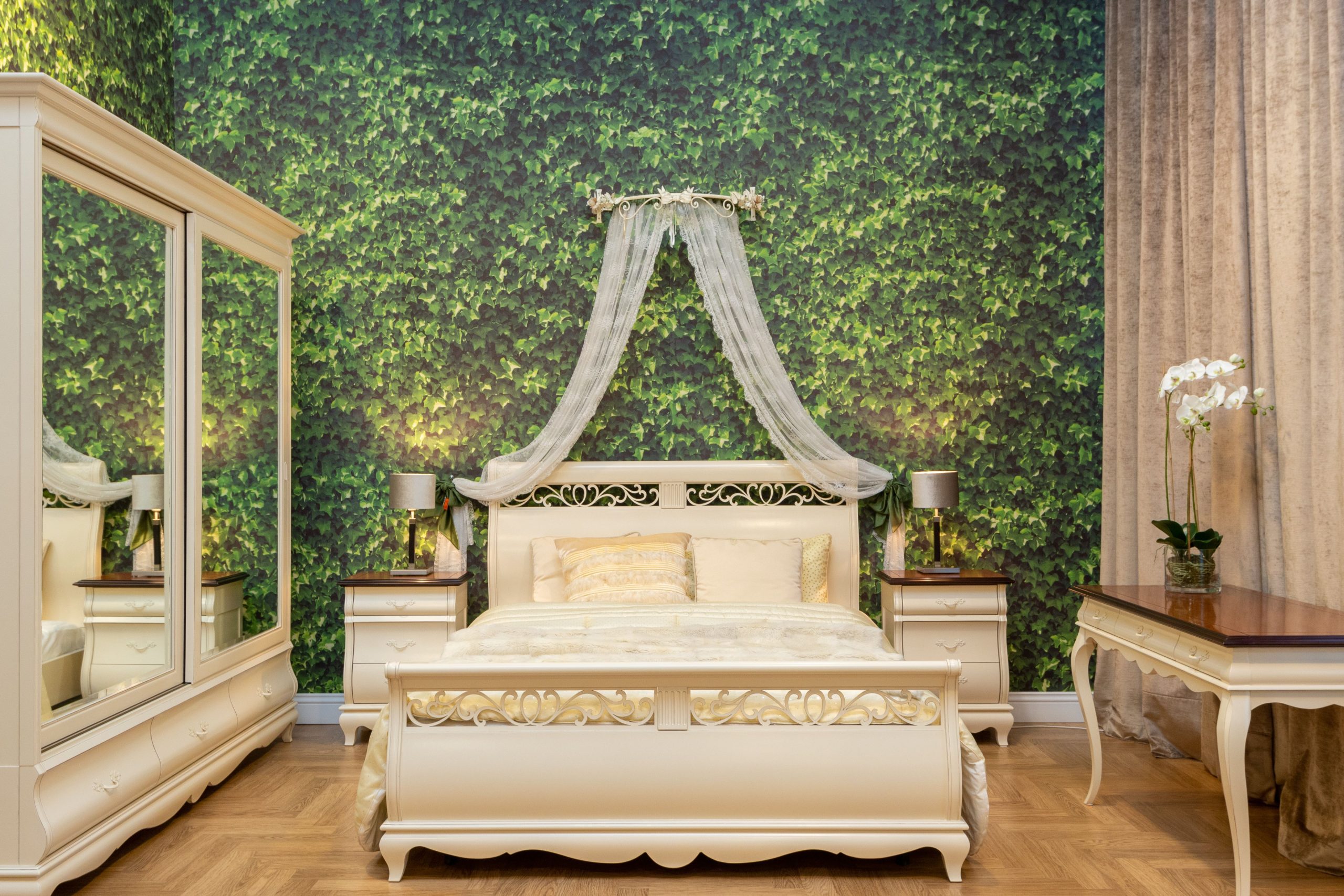 Luxury bedroom featuring elegant furniture and a nature-themed wall design, ideal for cozy interiors.