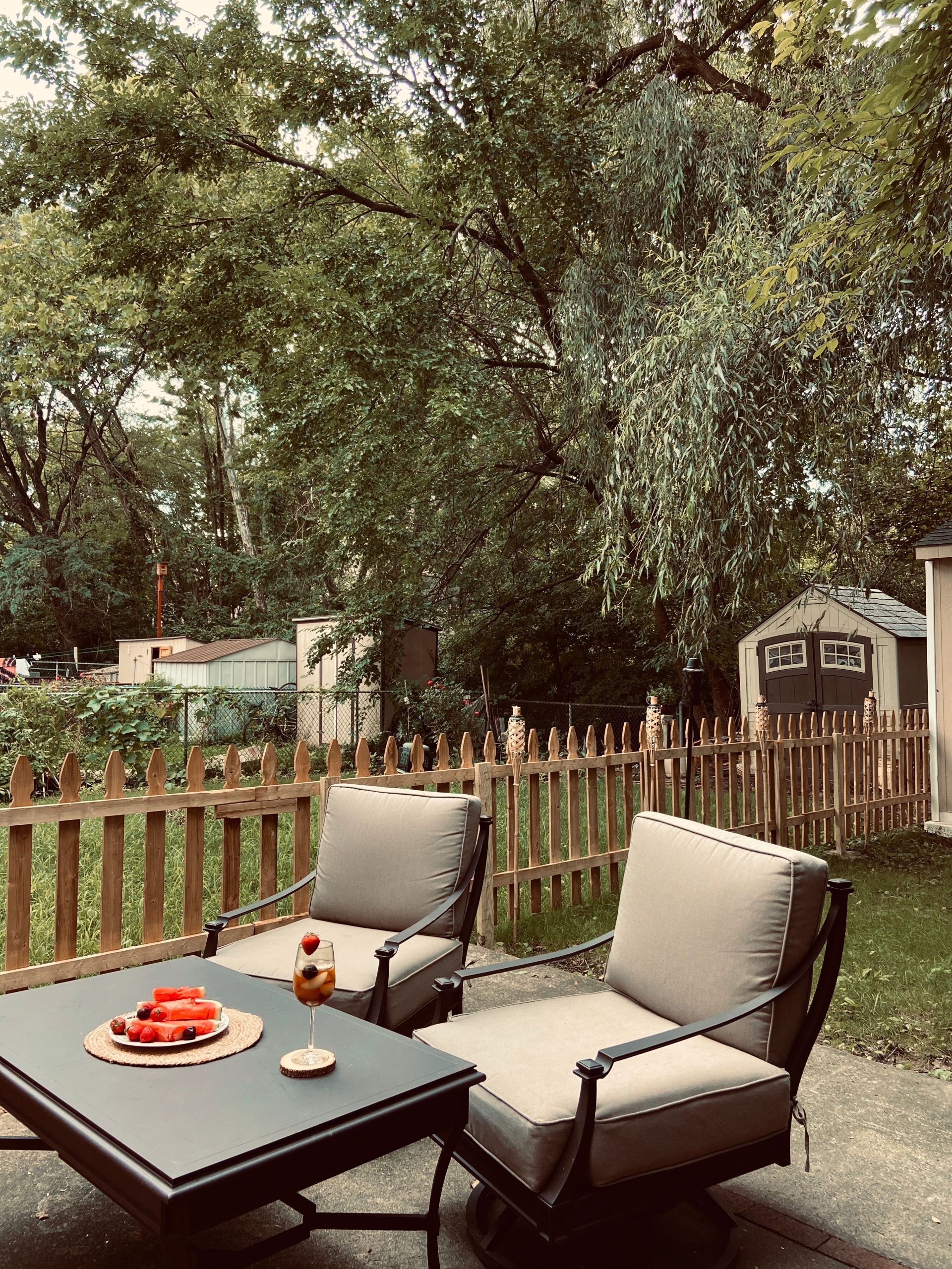 Relaxing outdoor seating area with armchairs and table in a Philadelphia backyard.