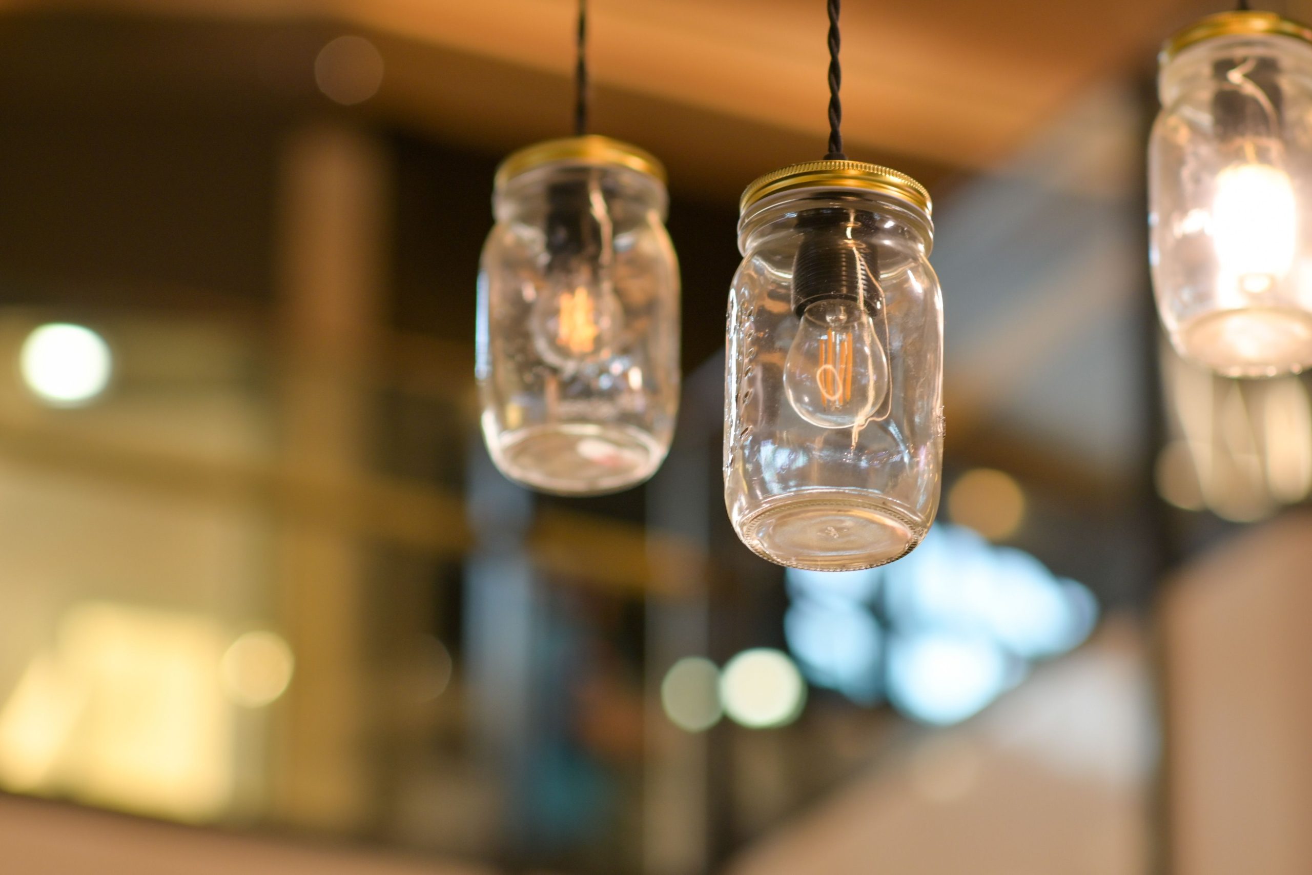 Stylish mason jar lights hanging indoors, creating a warm ambiance.