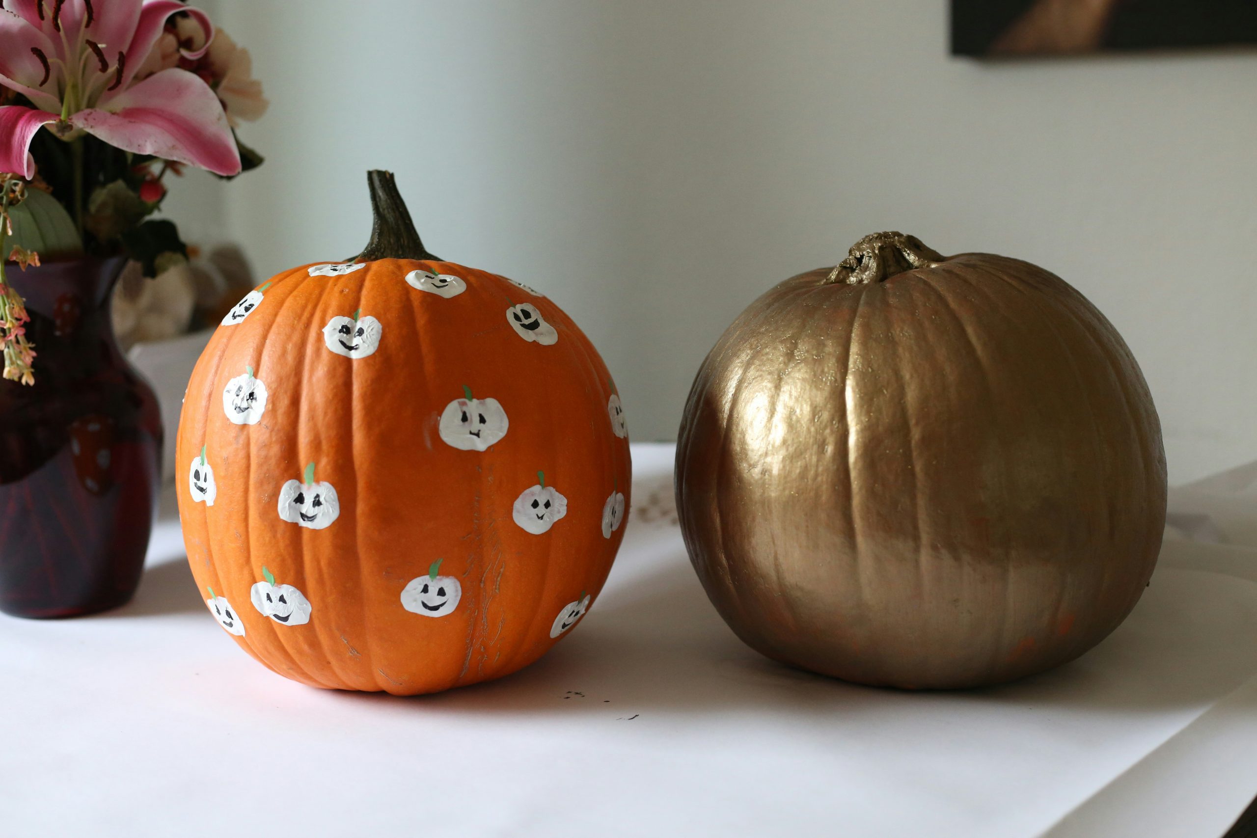 a couple of pumpkins sitting on top of a table