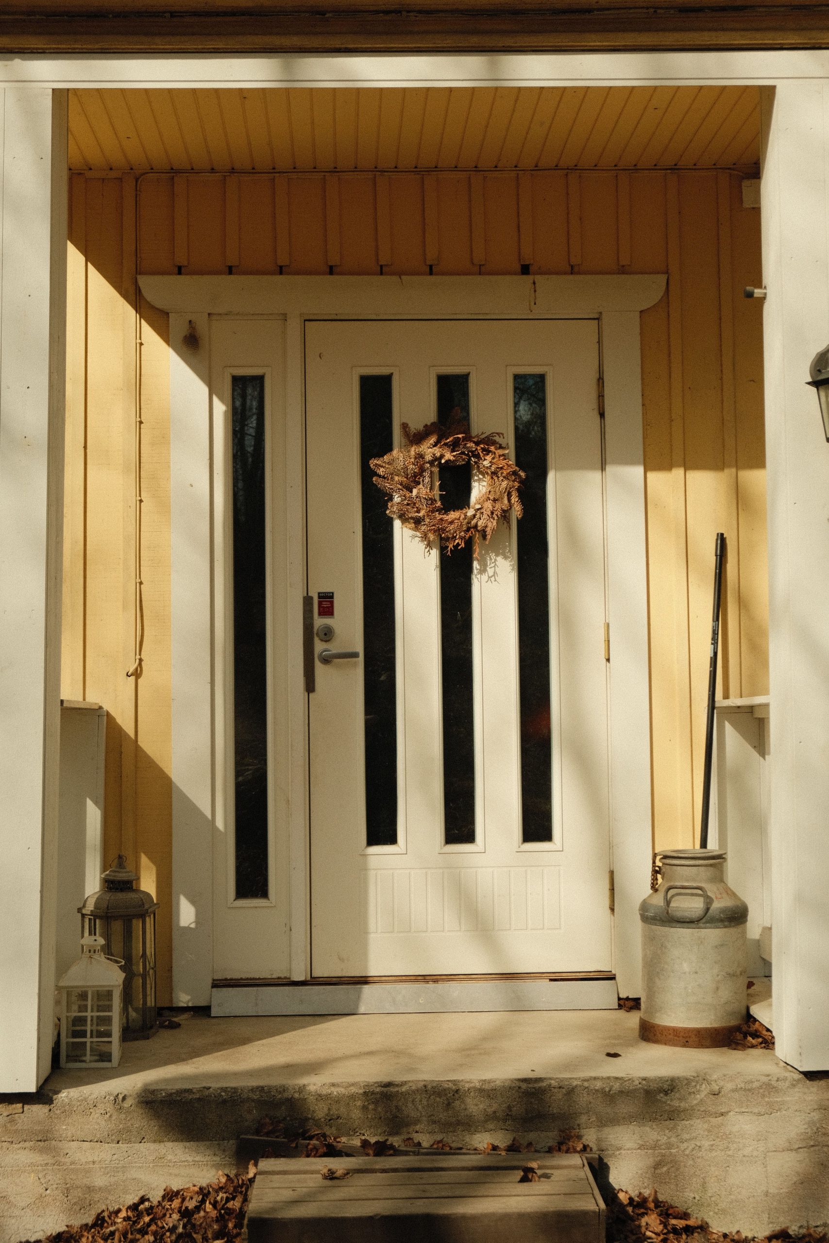 A cozy entrance with a wreath on a wooden door in Lahti, Finland.