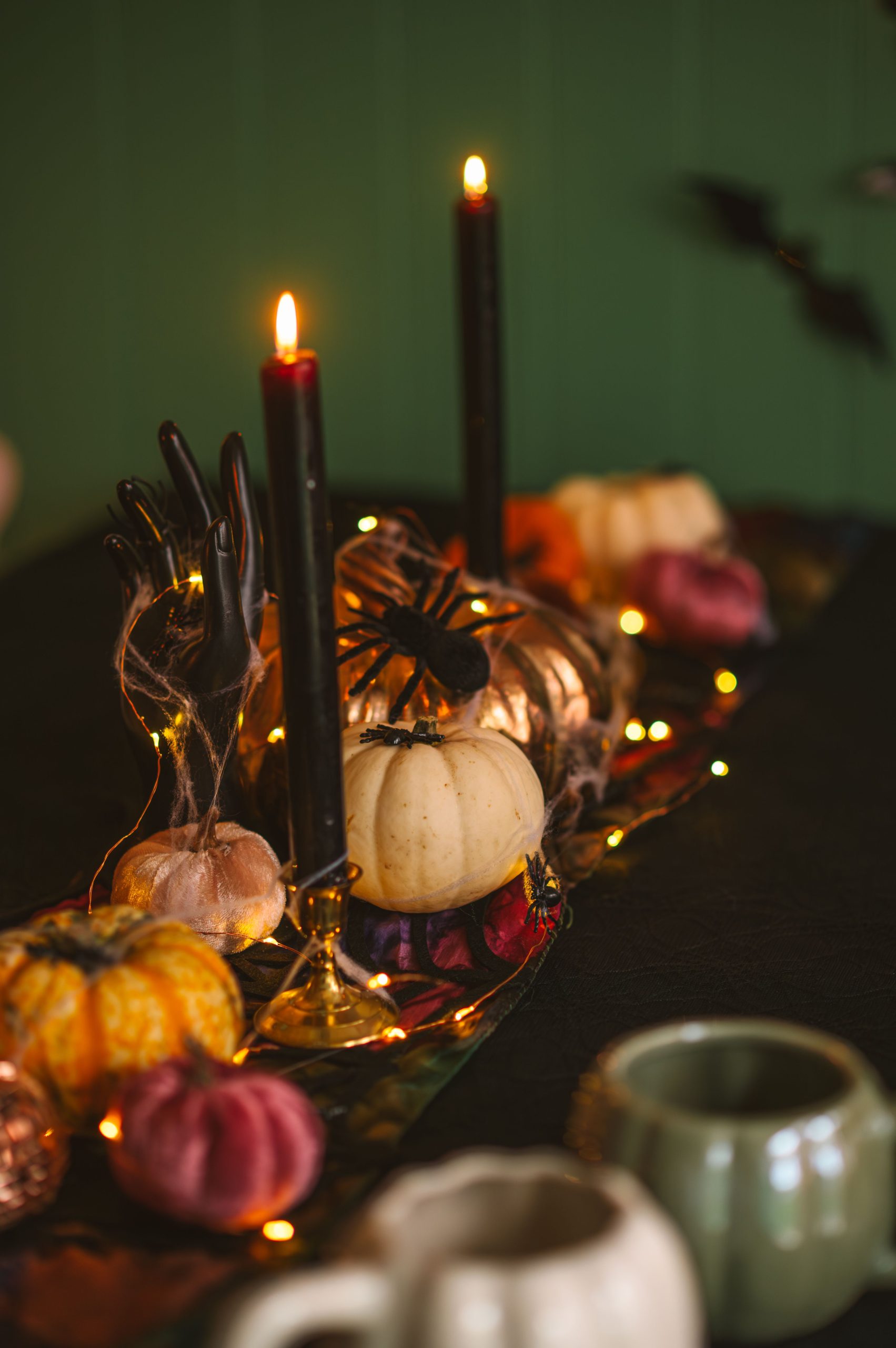A festive Halloween table setting with pumpkins, candles, and decorative lights ideal for autumn celebrations.