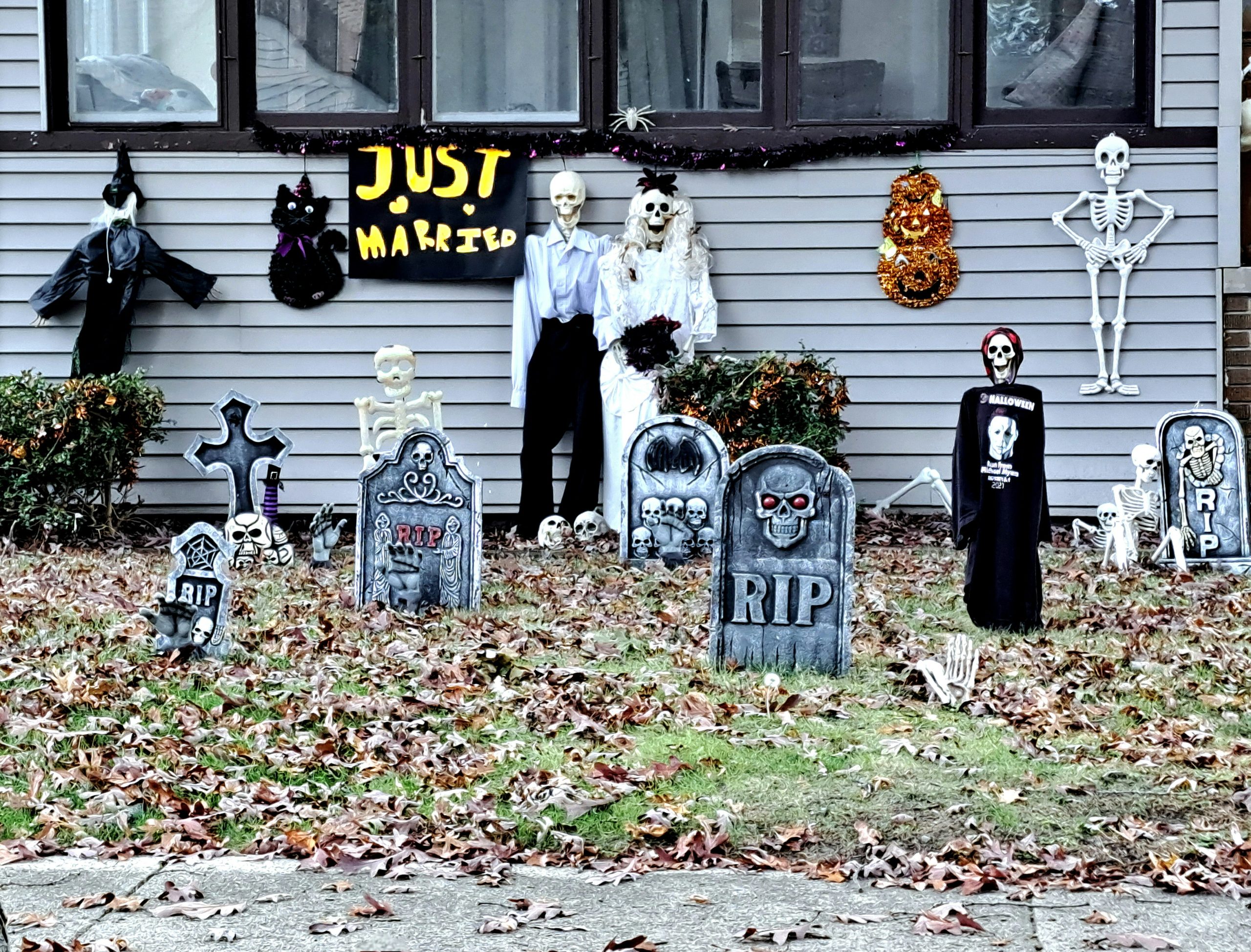 A house decorated for halloween with tombstones and decorations
