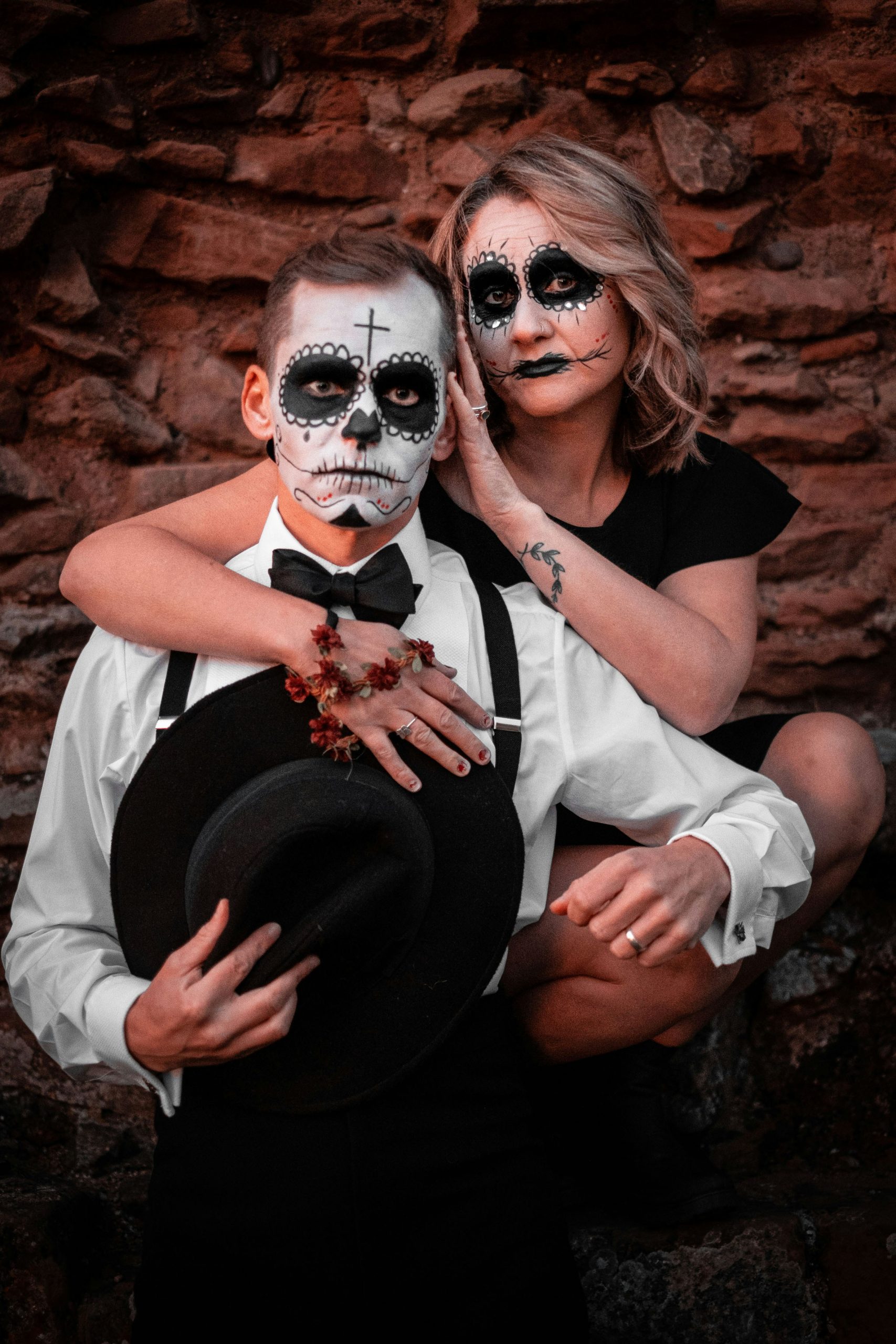 a man and a woman in skeleton makeup