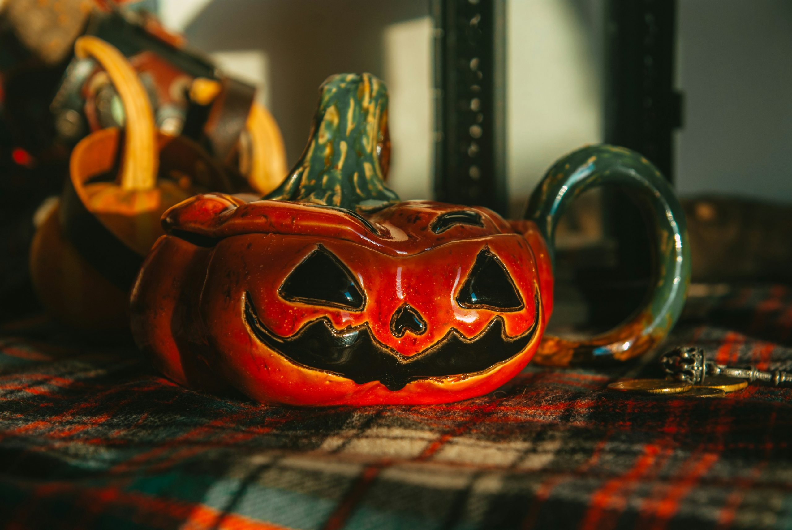 a pumpkin shaped teapot sitting on top of a table