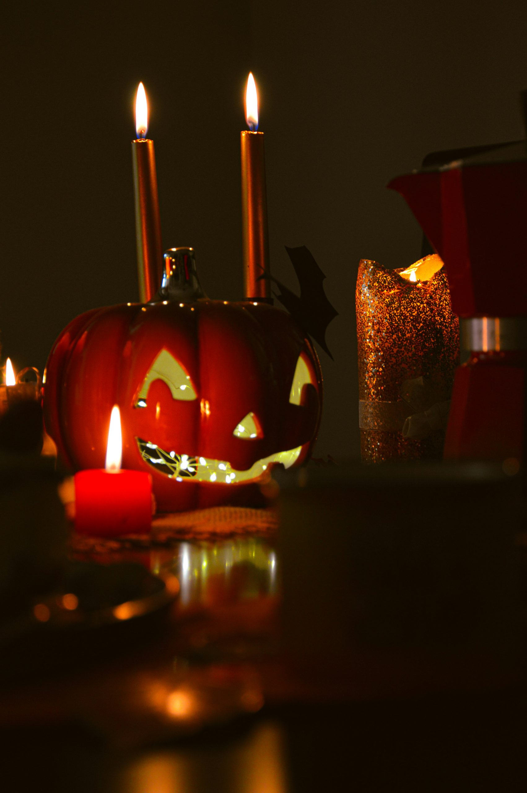 a pumpkin with a face carved into it sitting on a table