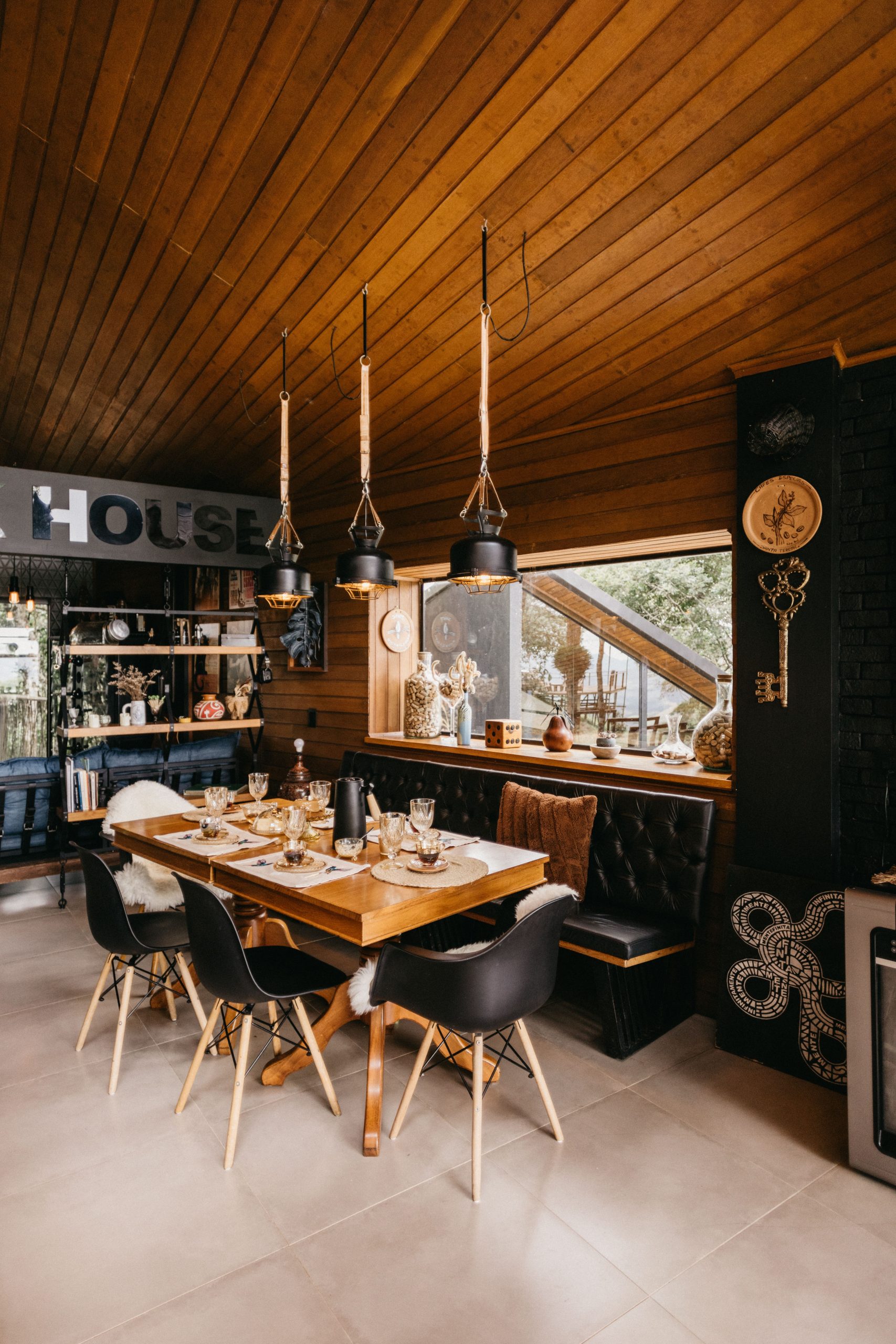 A stylish dining room with a rustic wood ceiling and modern decor in Brazil.