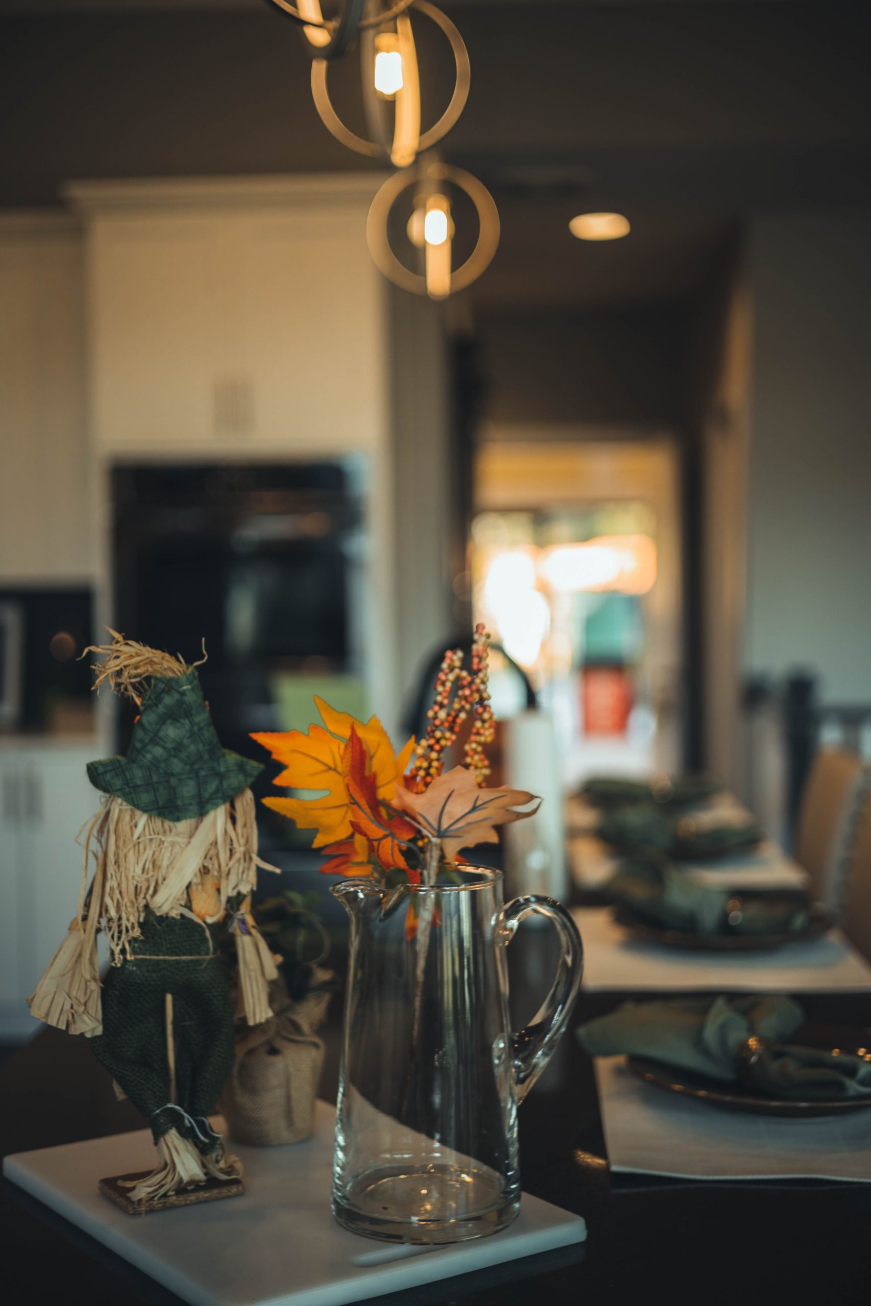 A warm, inviting table setting featuring autumn-themed decor and rustic accents in a cozy dining room.