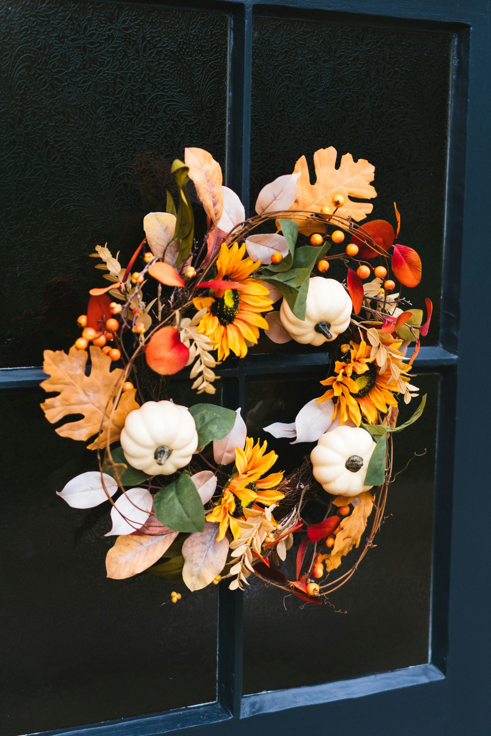 A wreath is hanging on a window sill