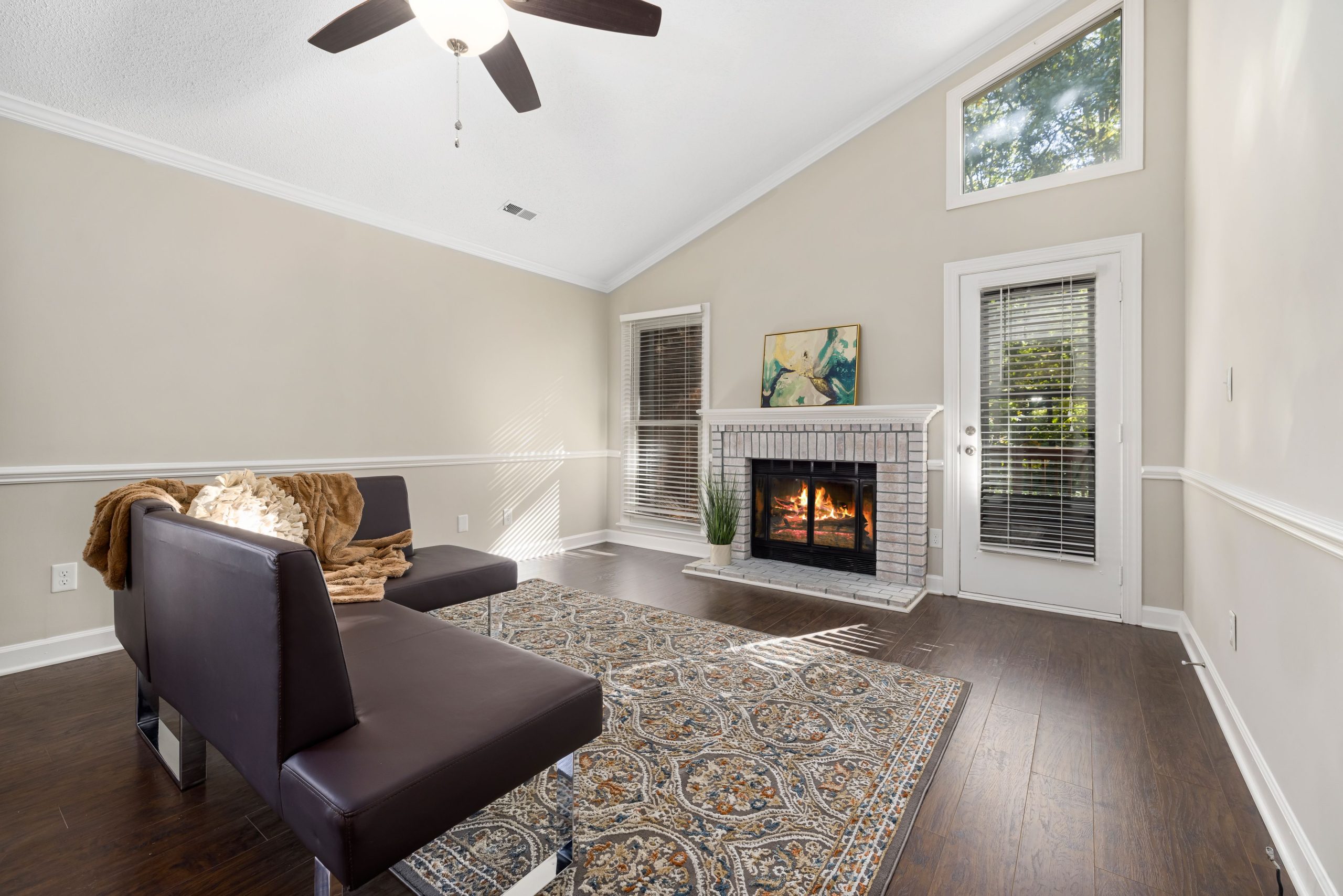 Bright and inviting living room featuring a modern sofa, fireplace, and elegant decor.