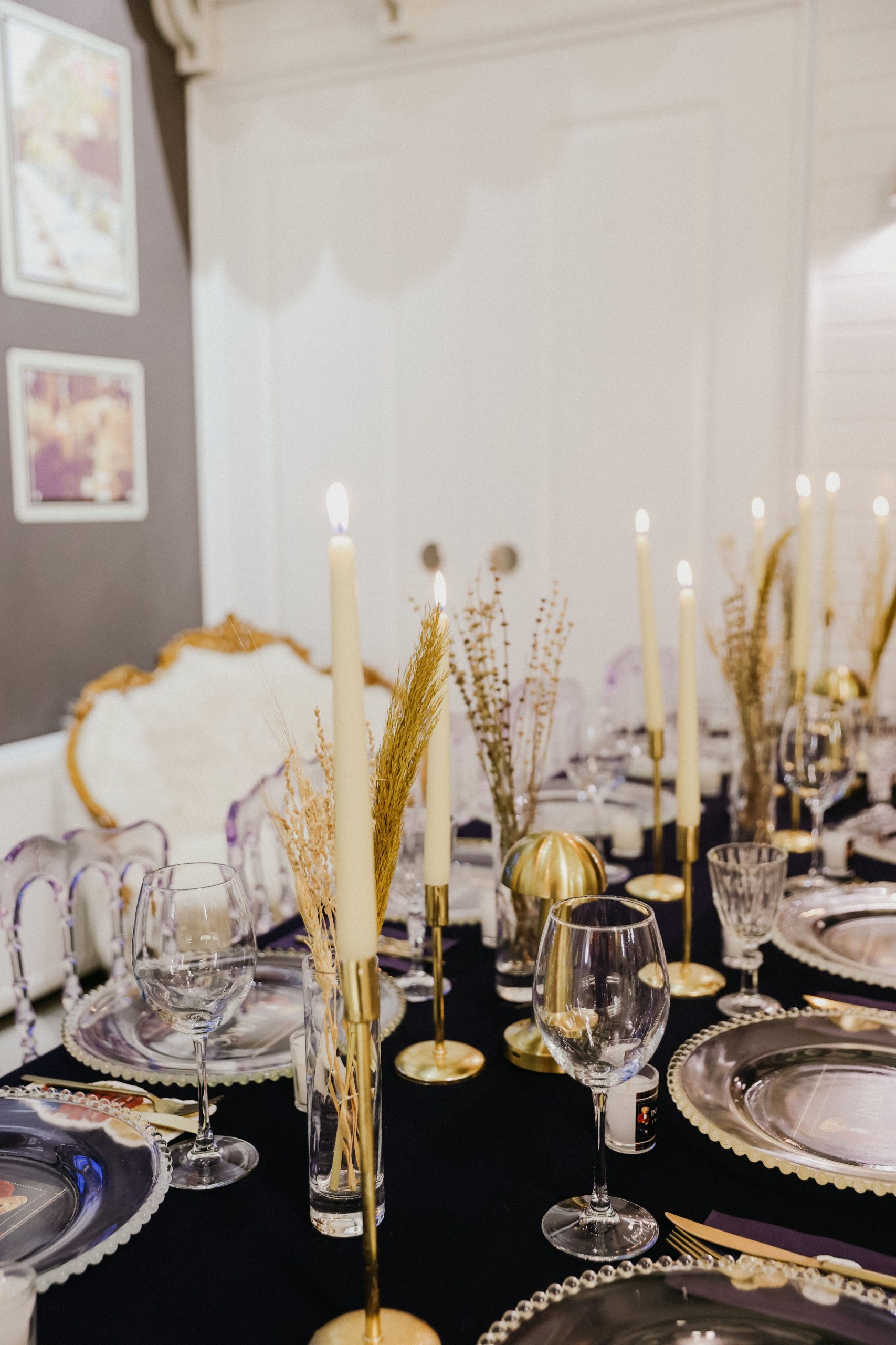Candlelit dinner table setting with elegant decor, fine china, and crystal glassware creating a luxurious ambiance.