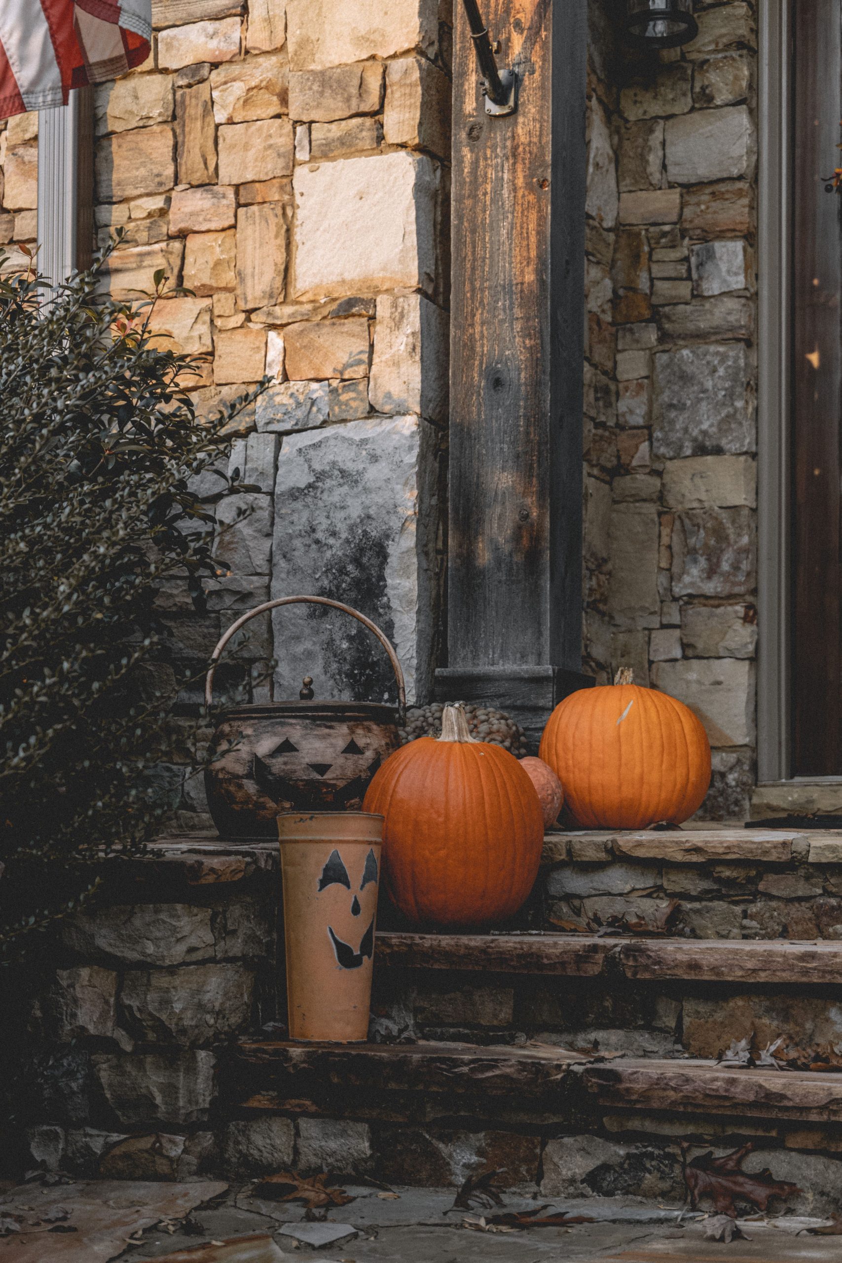 Charming rustic porch decorated with pumpkins for Halloween, perfect autumn ambiance.
