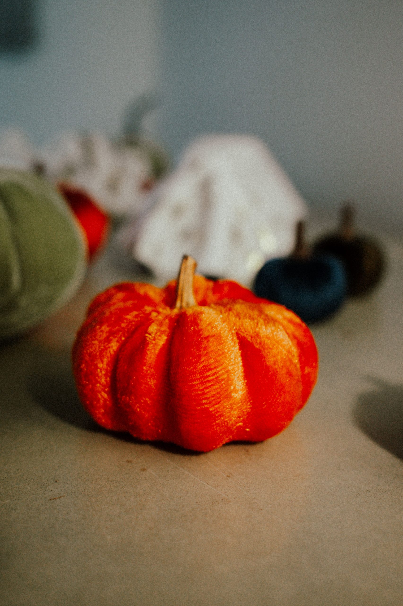 Close-up of a vibrant velvet pumpkin, perfect for fall decorations.
