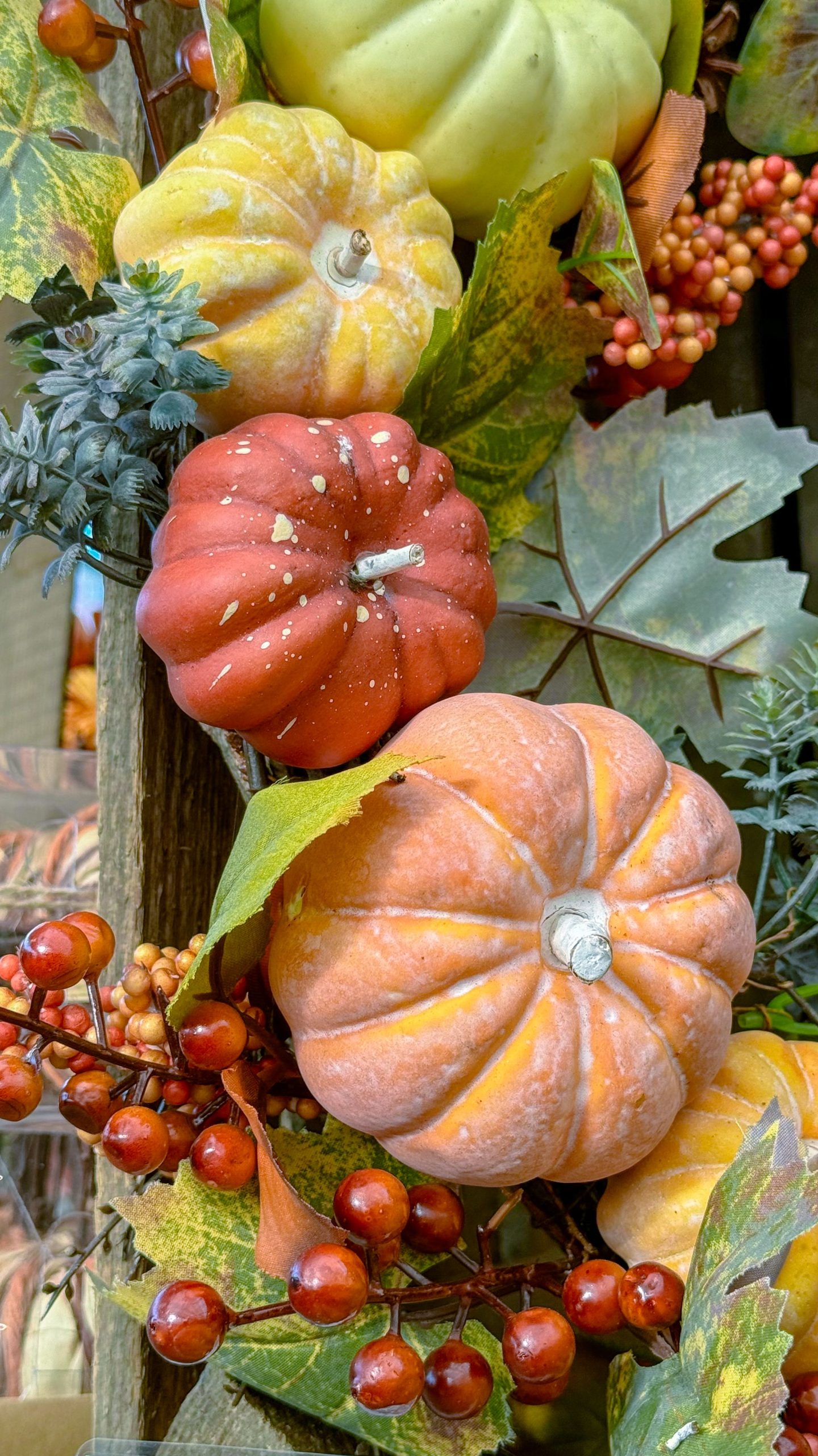 Colorful assortment of pumpkins and fall leaves in a festive autumn harvest display.